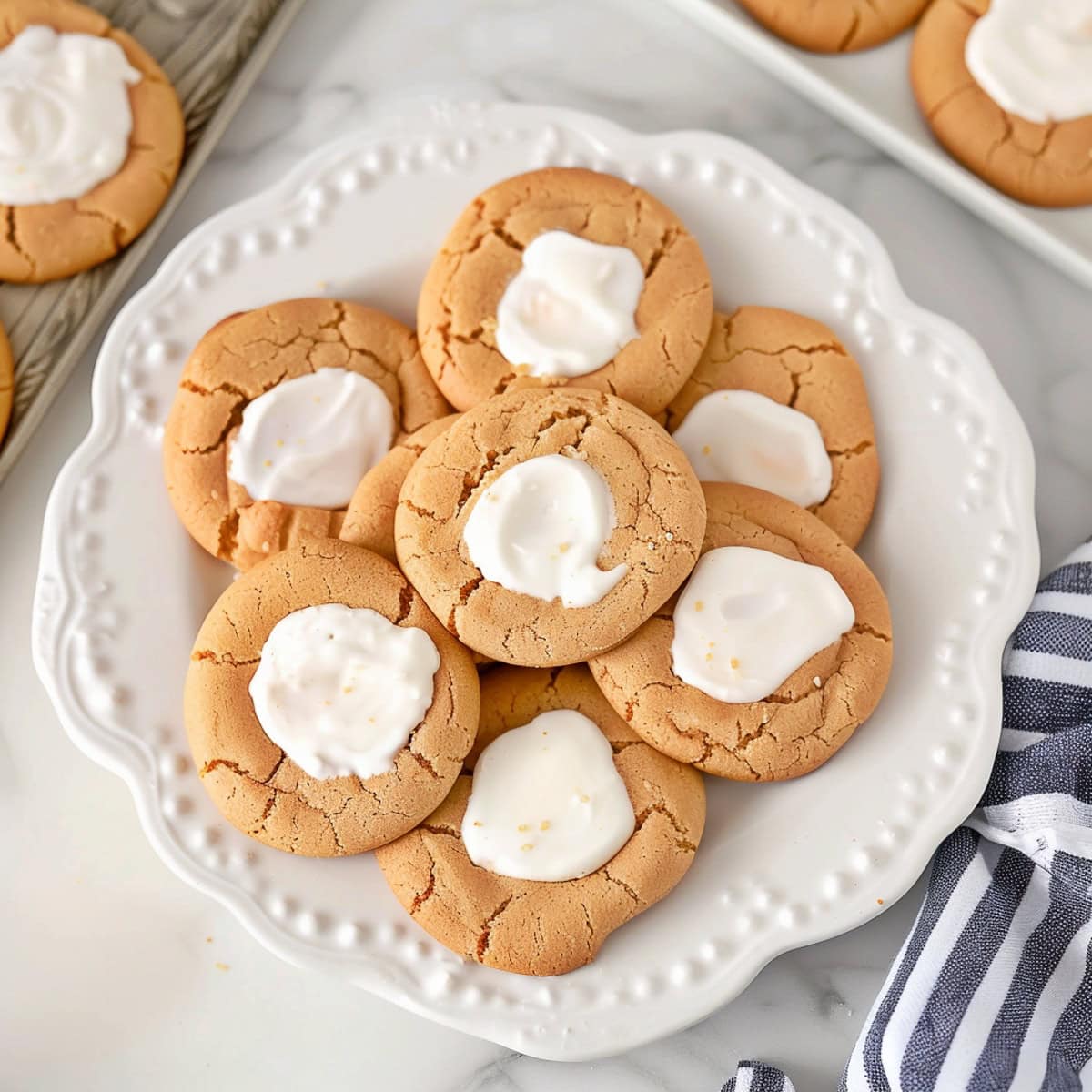 Elegant fluffernutter cookies, arranged on a white plate.