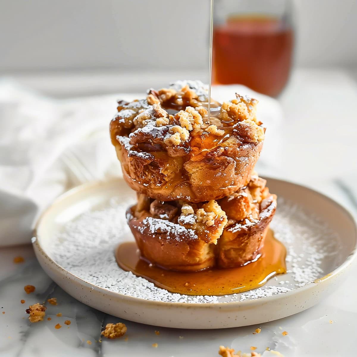 Drizzling Maple Syrup into a Stack of French Toast Muffins.