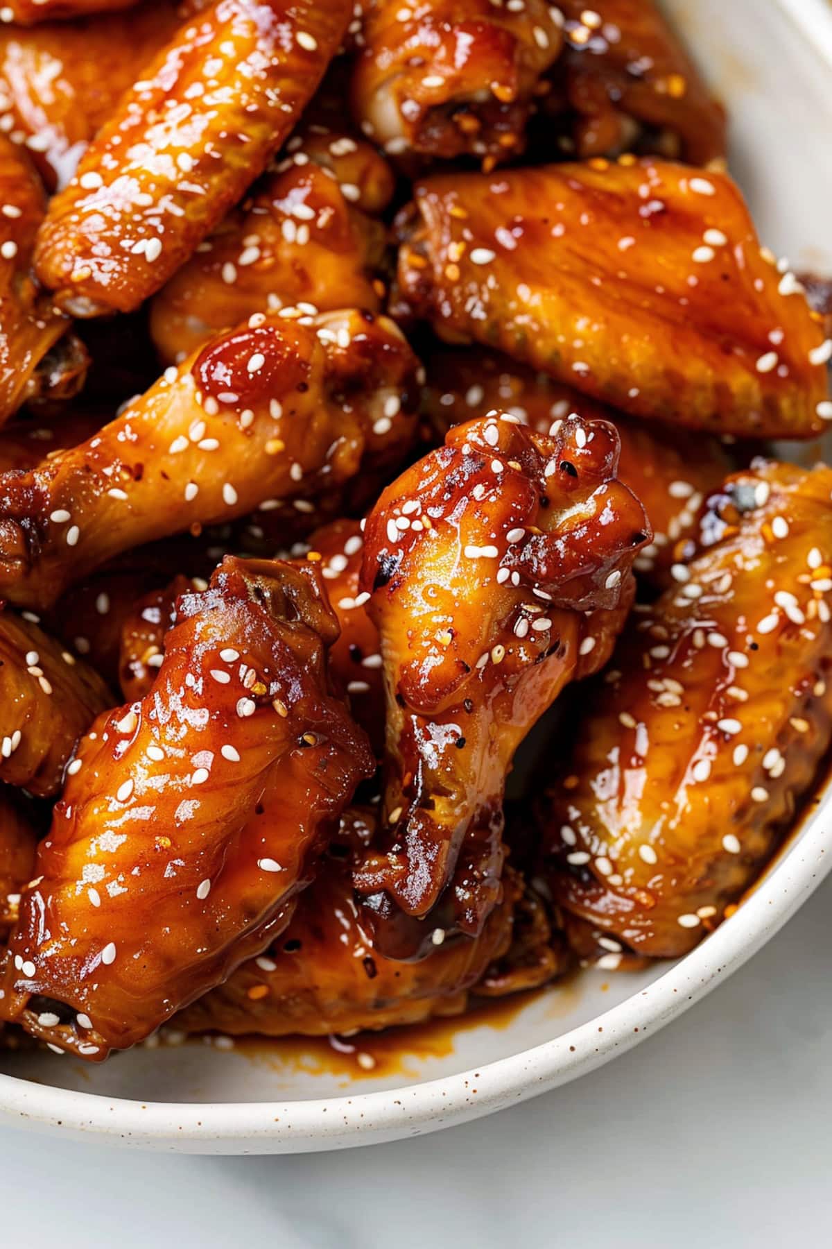 Delicious honey garlic chicken wings, glazed with a sweet and savory sauce, garnished with sesame seeds.