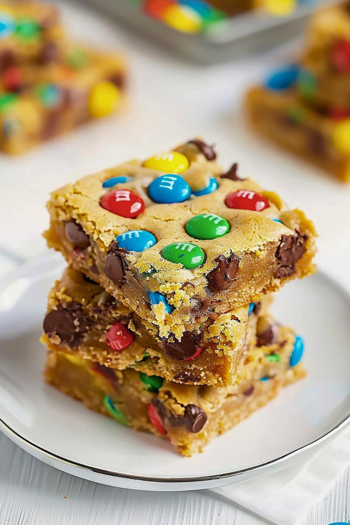 Homemade M&M cookie bars with a soft, chewy interior and a crispy, golden crust.