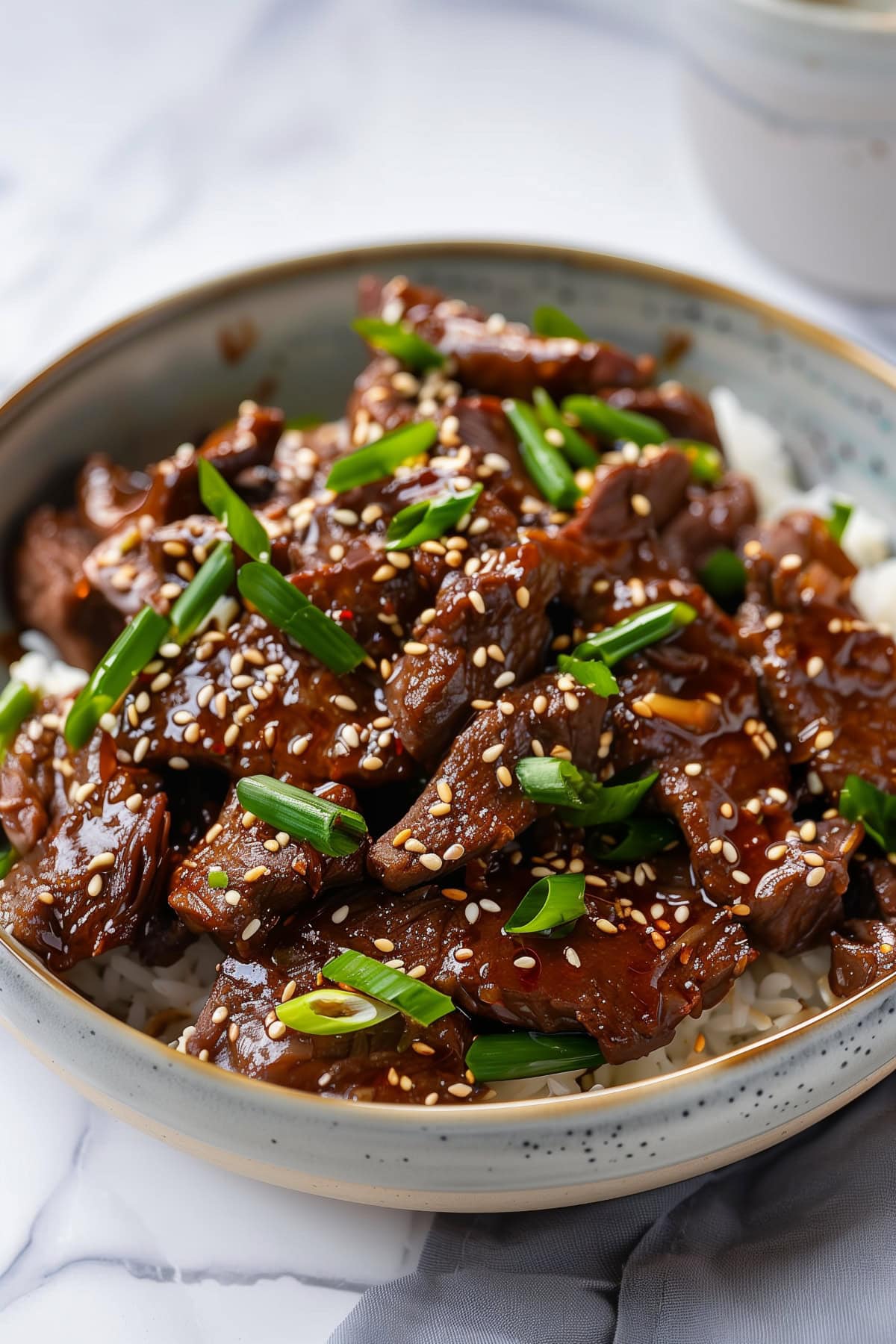 A bowl of Mongolian beef with rice