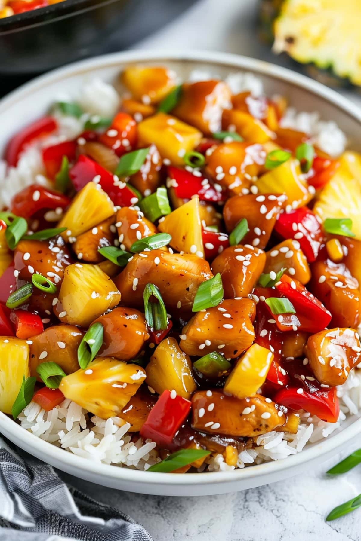 Stir fry chicken tenders with pineapples and bell peppers.