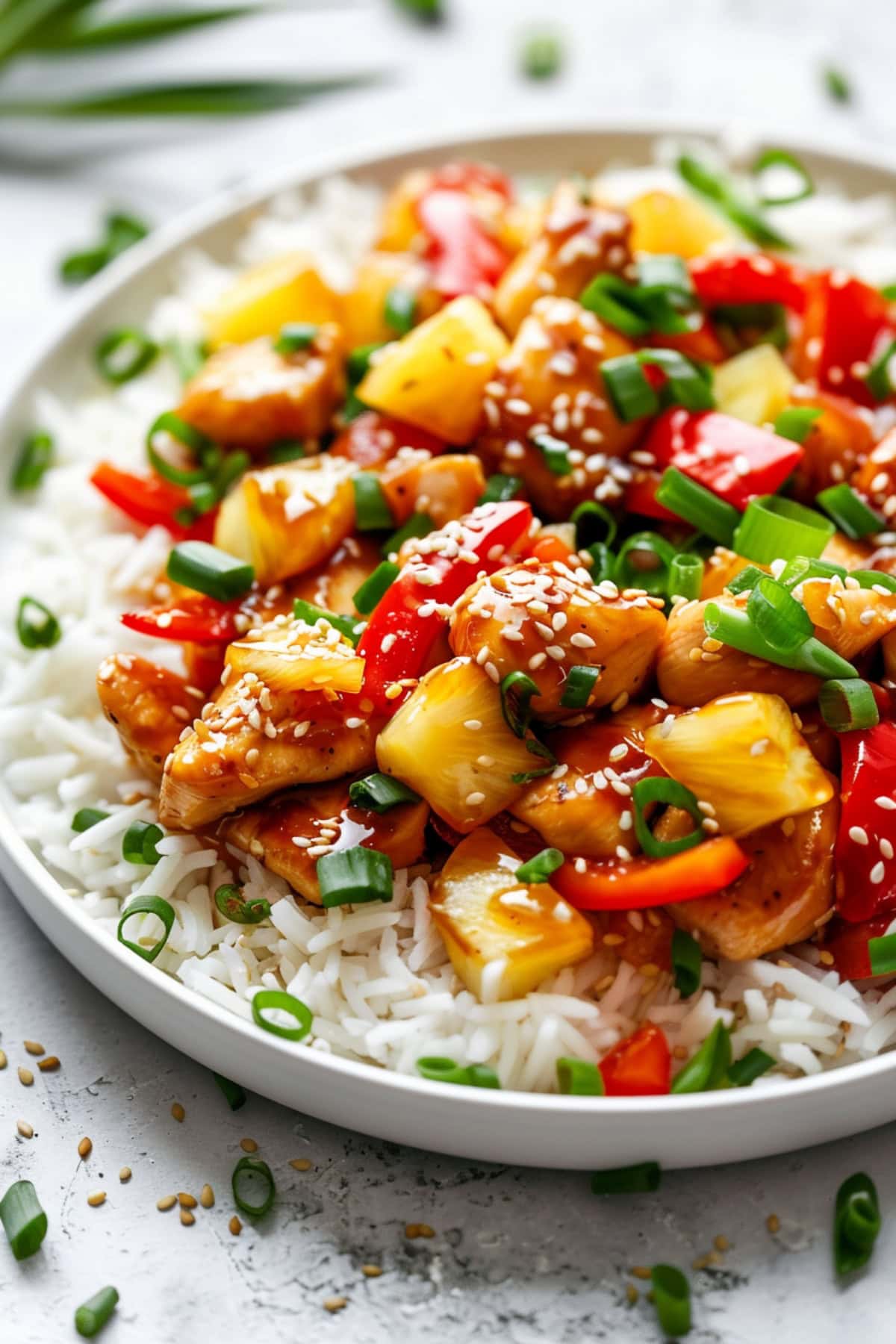 Chicken tenders in sweet sauce with bell peppers and pineapple chunks.