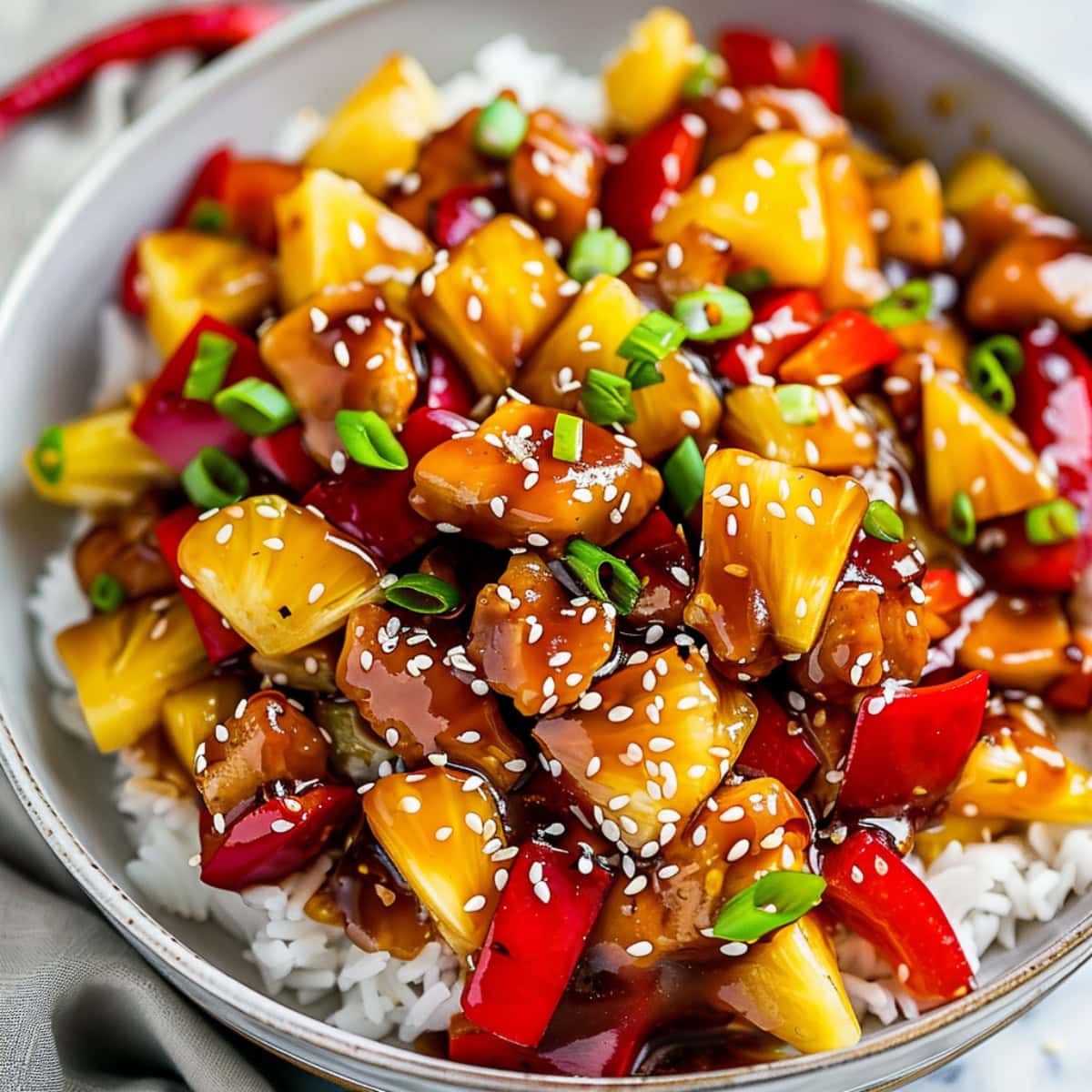 Stir fried chicken tenders with pineapple chucks, bell peppers and green onions.