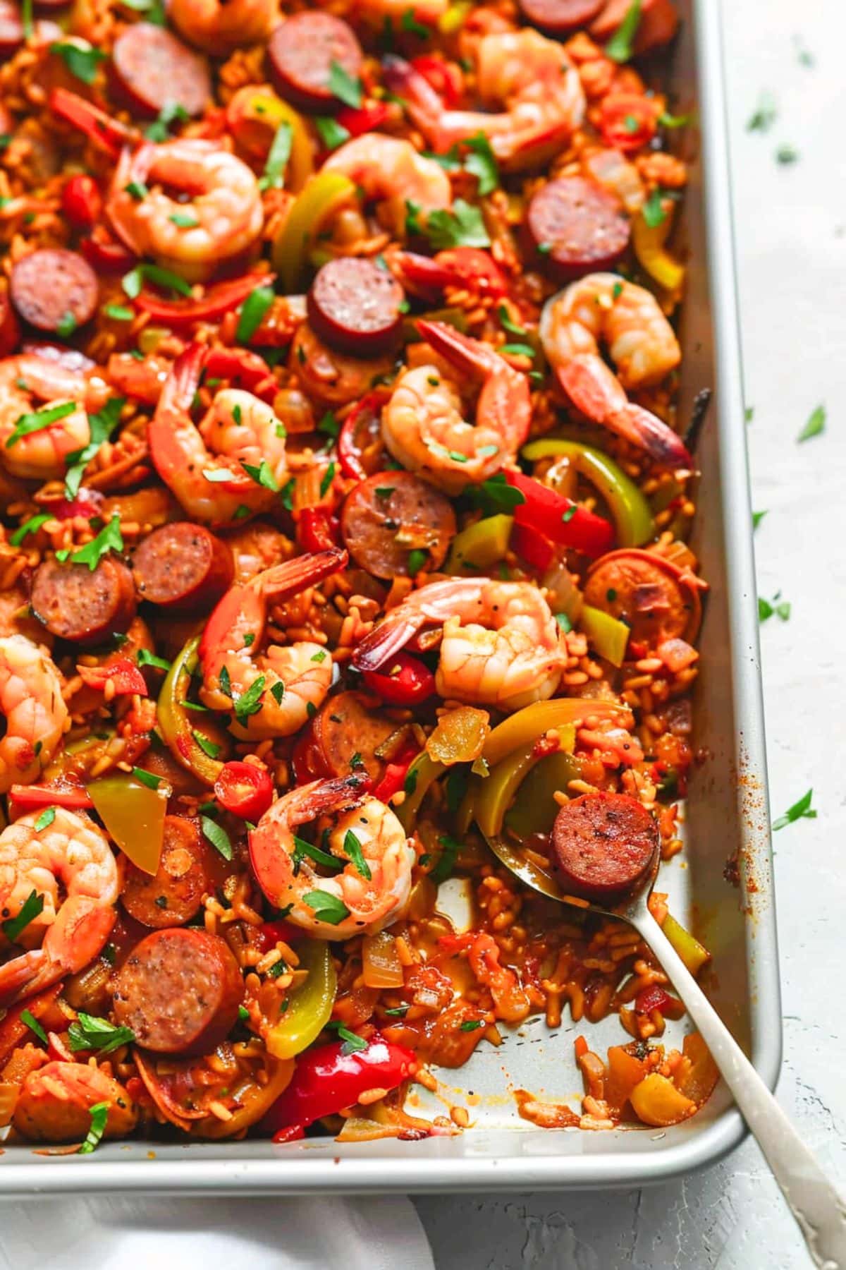 Spoon in Jambalaya cooked in sheet pan. 