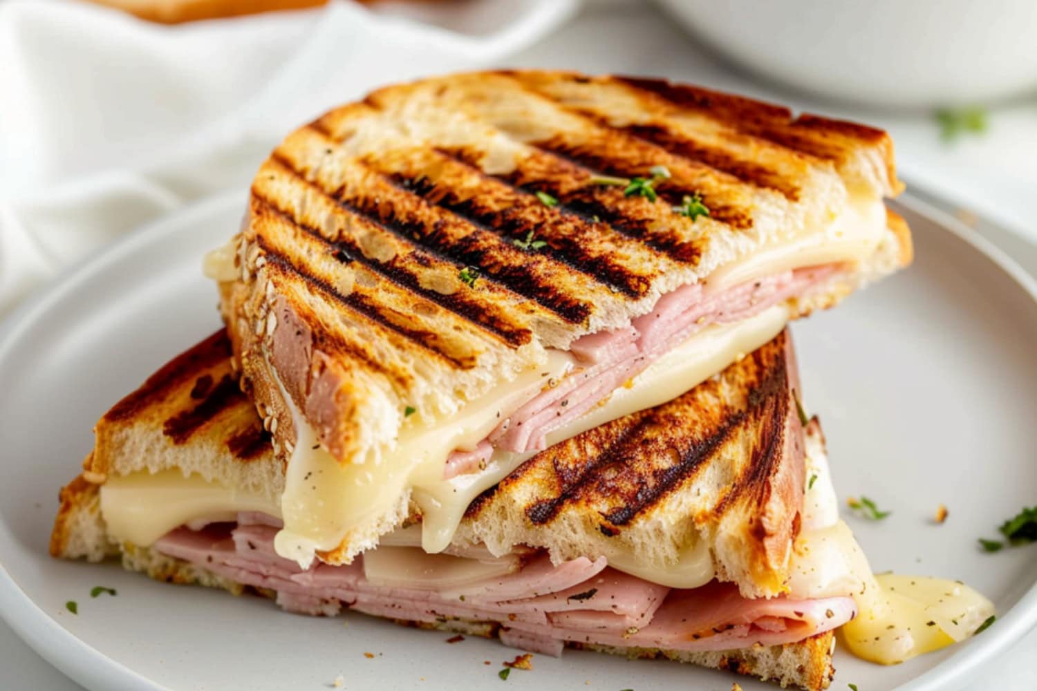 Panini press with Swiss cheese, tender ham, softened butter and tangy mustard.