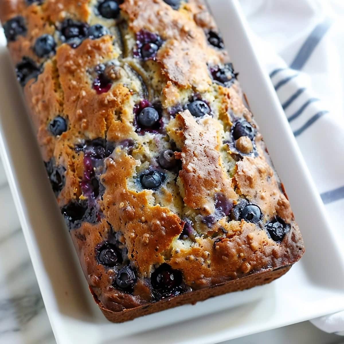 Whole Blueberry Banana Bread in a White Platter