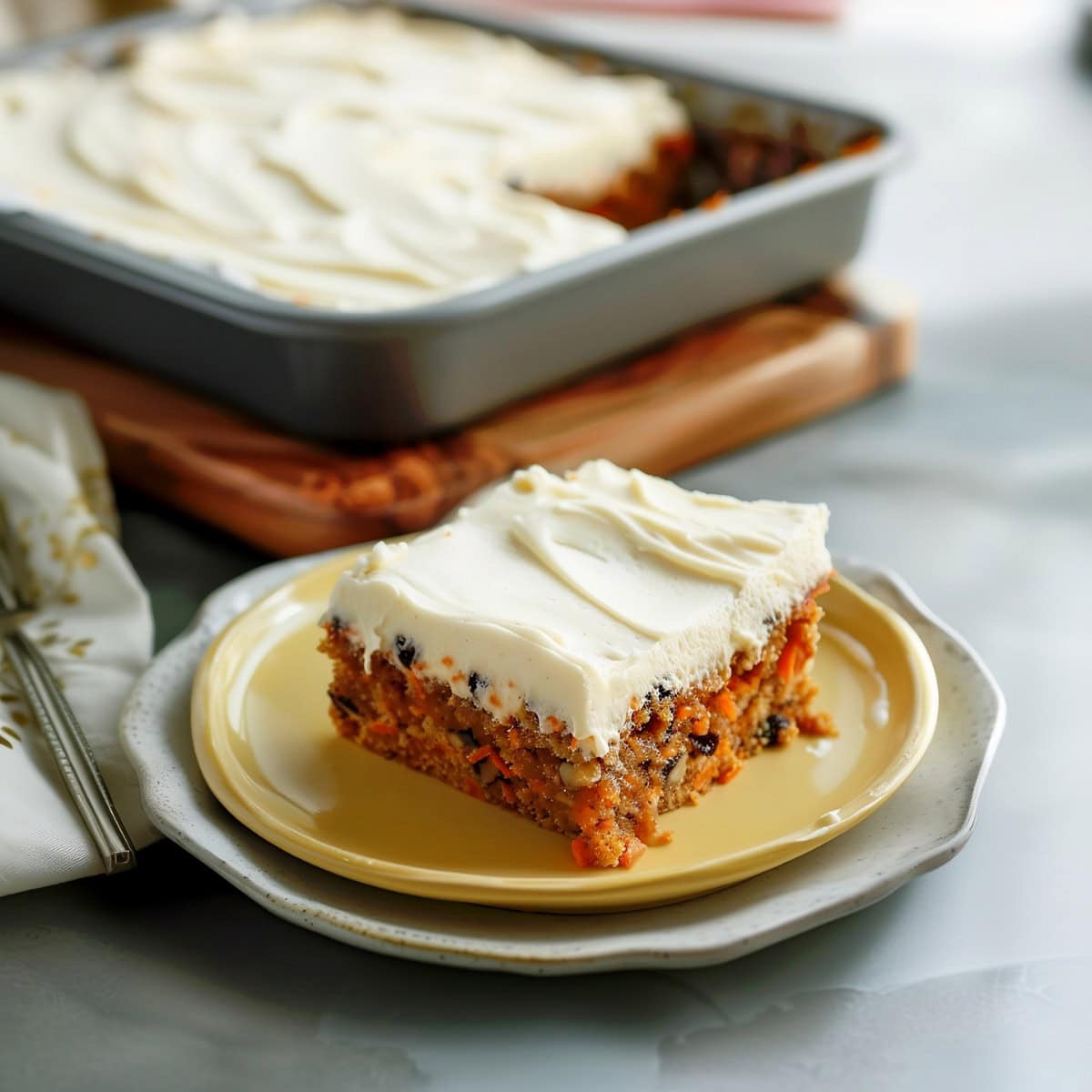 A carrot sheet cake with raisins and pecans.