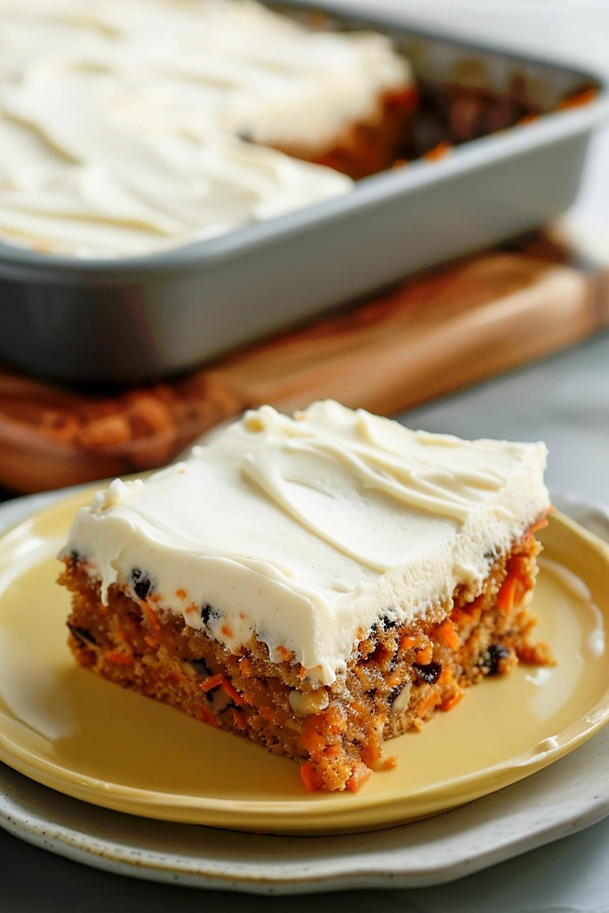  A slice of moist carrot cake in a plate.