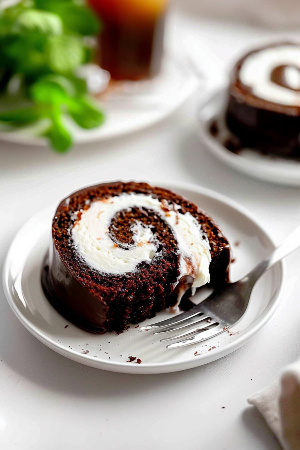 Chocolate Swiss Roll Cake On A Plate with Fork.