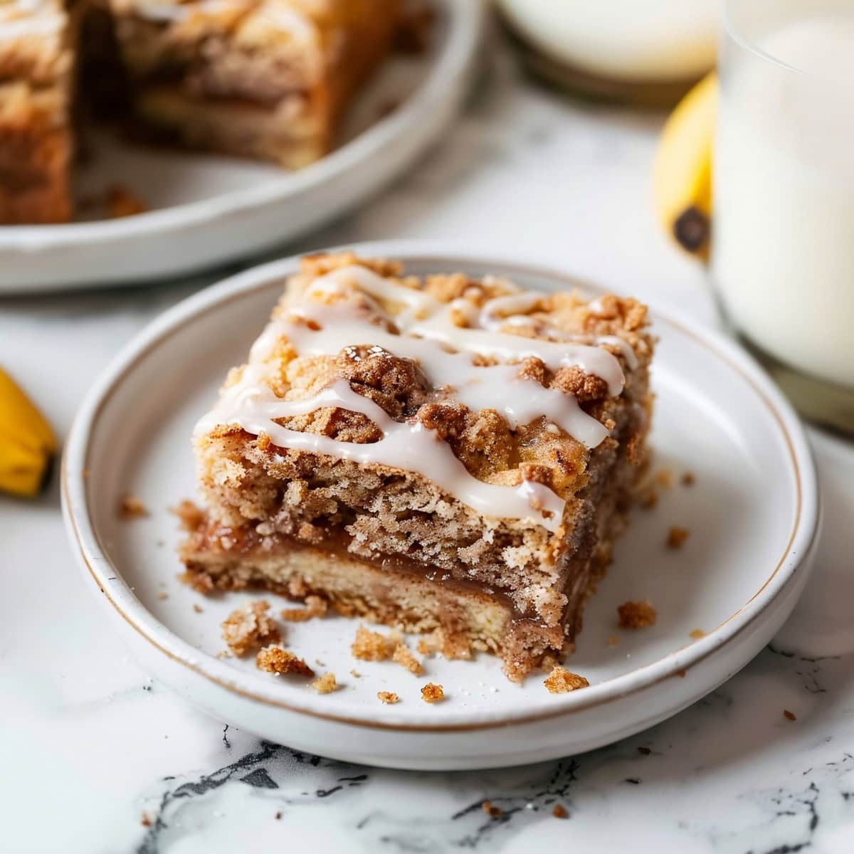 Irresistible coffee cake banana bread, sliced and ready to be served with a glass of milk.