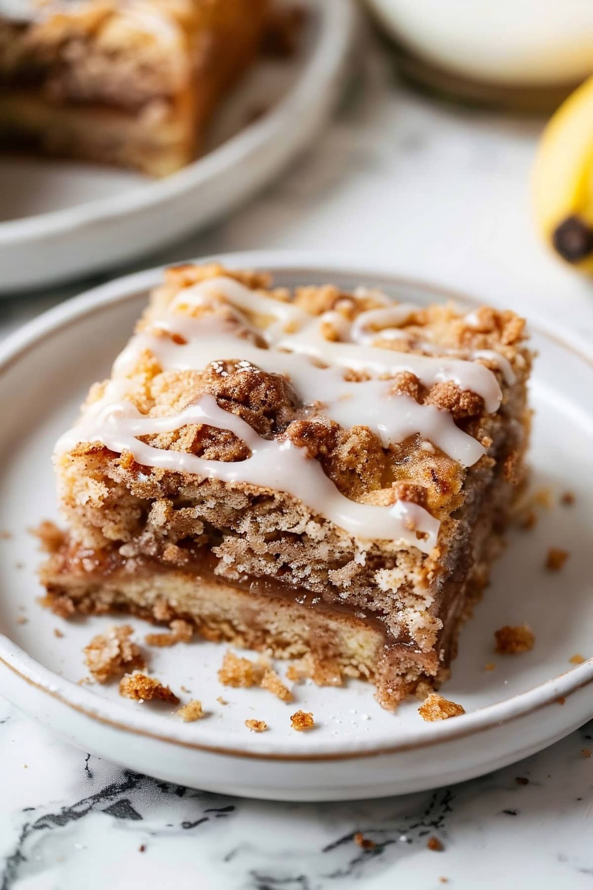 Coffee Cake Banana Bread with Glaze on a White Plate.