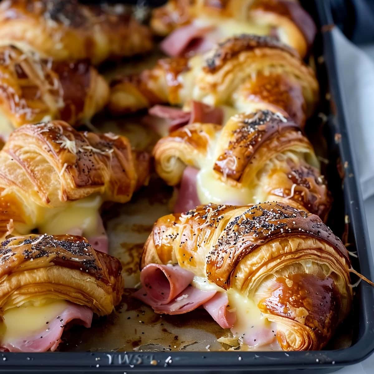 Ham and Cheese Croissant with Sesame Seeds On Baking Pan