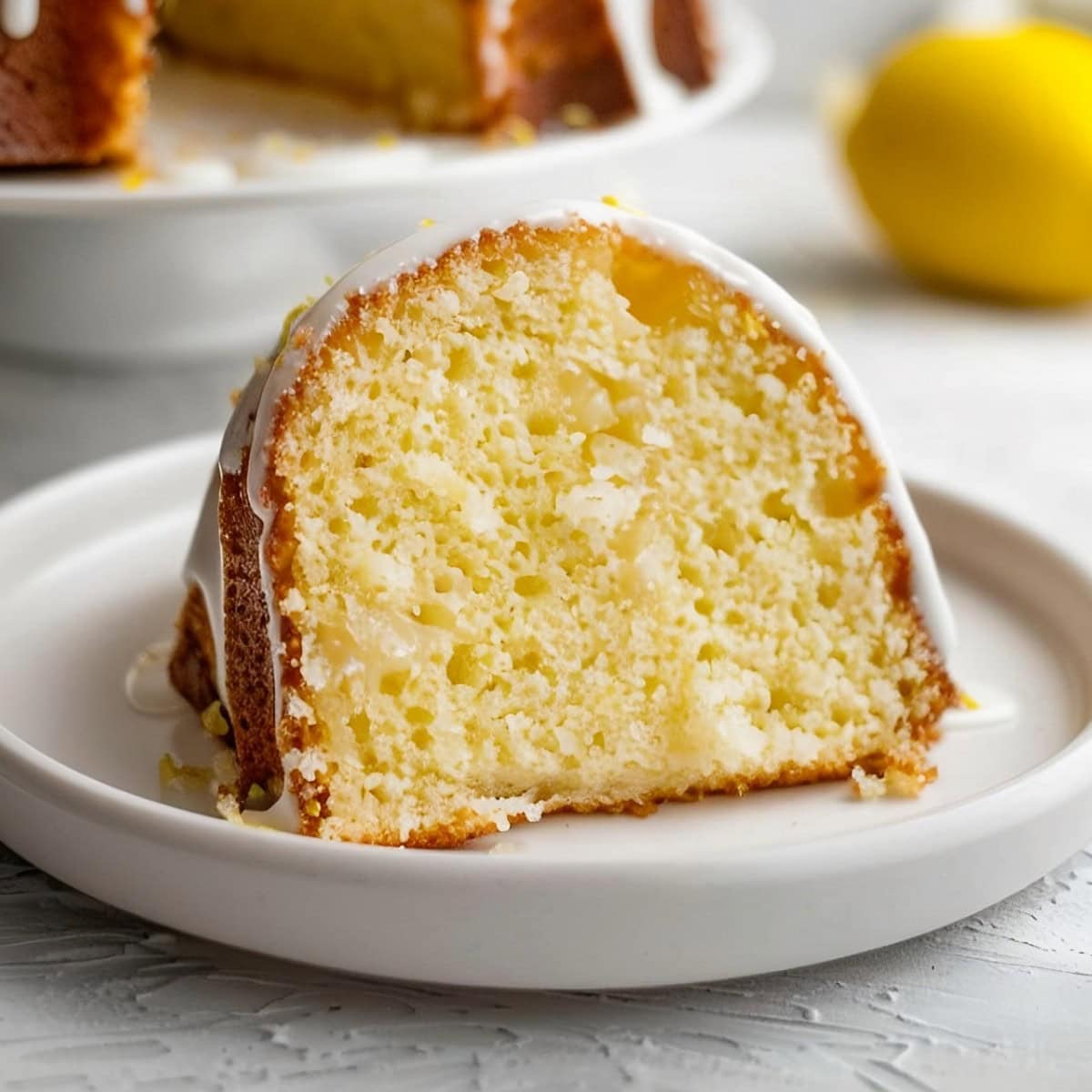 Lemon bundt cake slice on a plate, close up shot