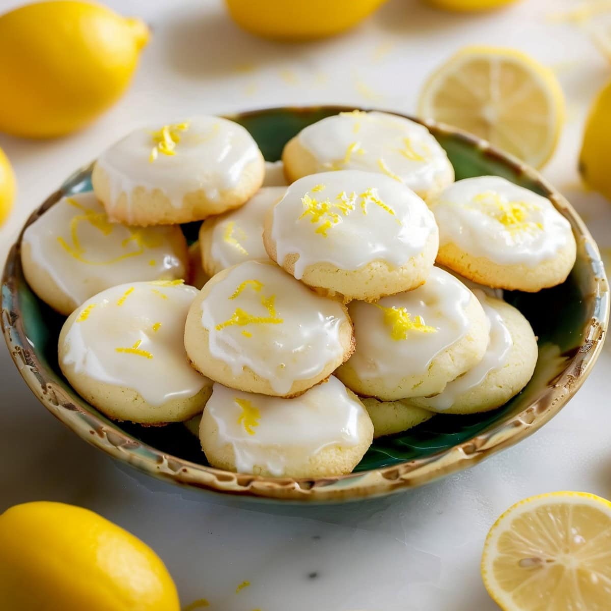 Lemon meltaway cookies in a vintage plate on a white marble table.