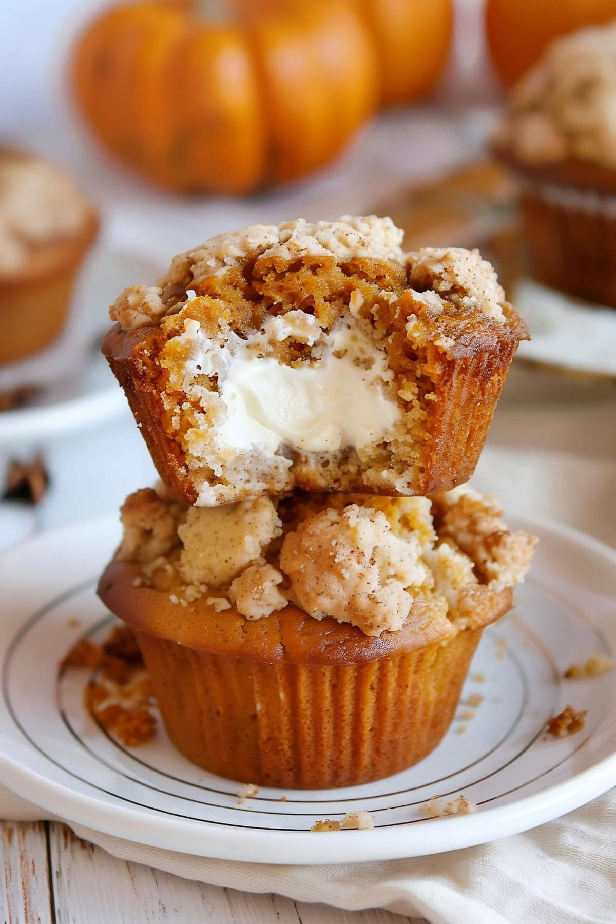 Pumpkin Cream Cheese Muffins Stacked in a Plate.