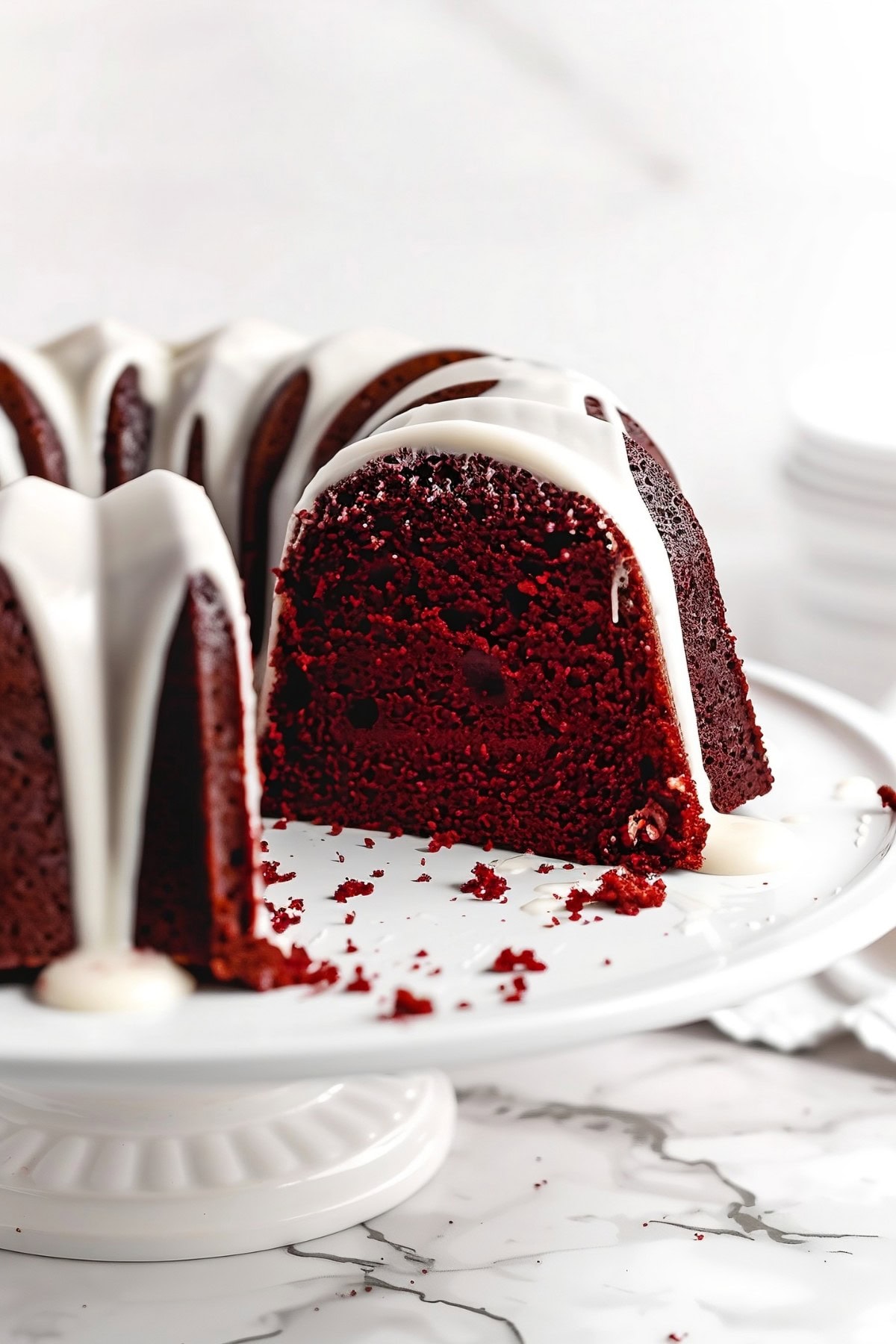 Red Velvet Bundt Cake with Glaze, and A Slice Removed, Close-Up