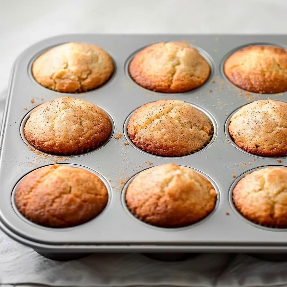 Snickerdoodle muffins in a muffin tip, fresh out of the oven. 