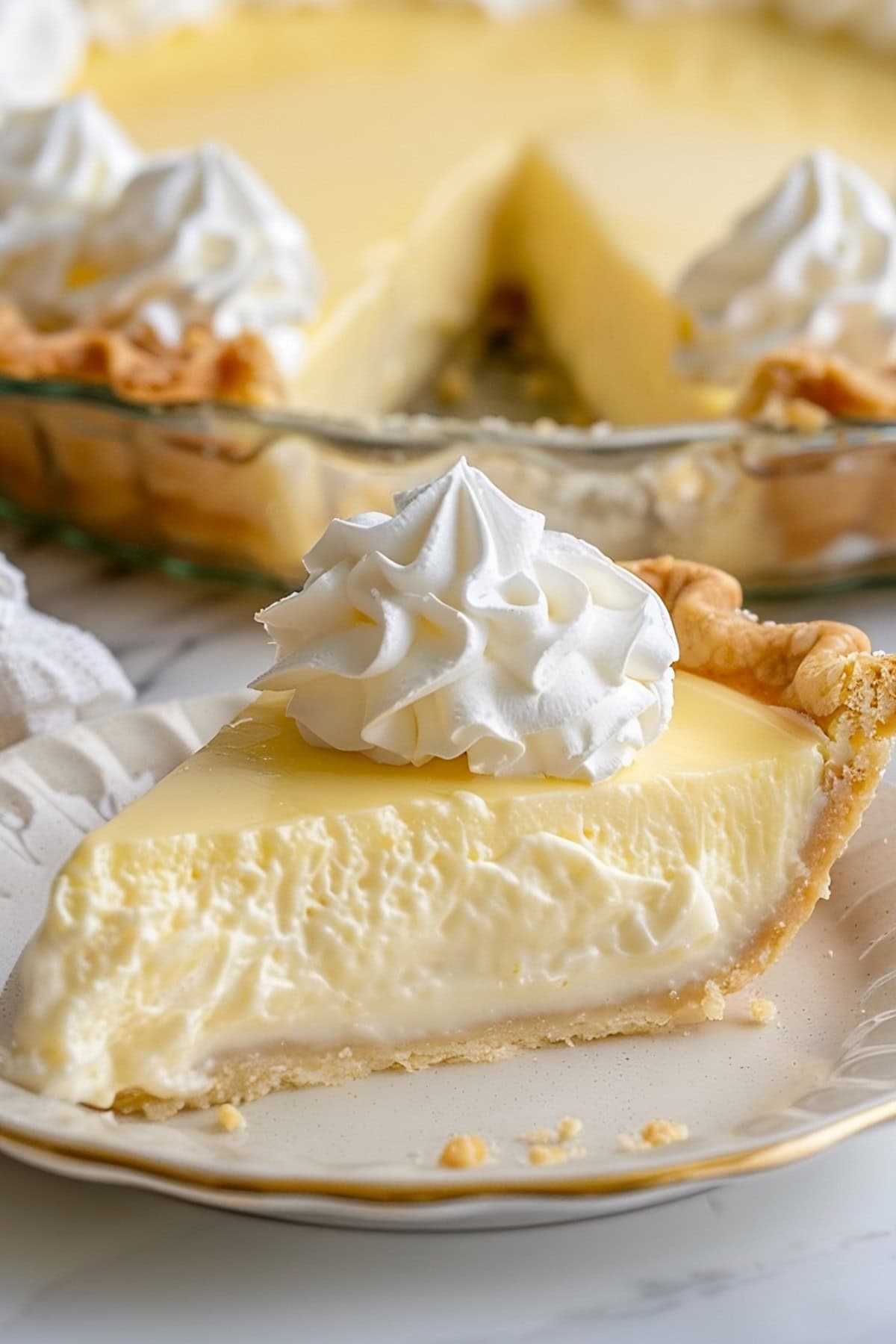 A slice of Vanilla Cream Pie on a plate.