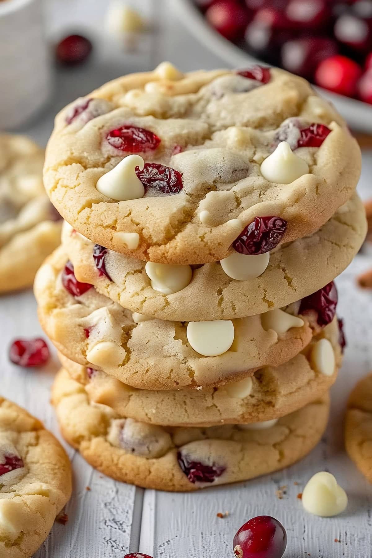 Stack of White Chocolate Cranberry Cookies on a wooden surface.