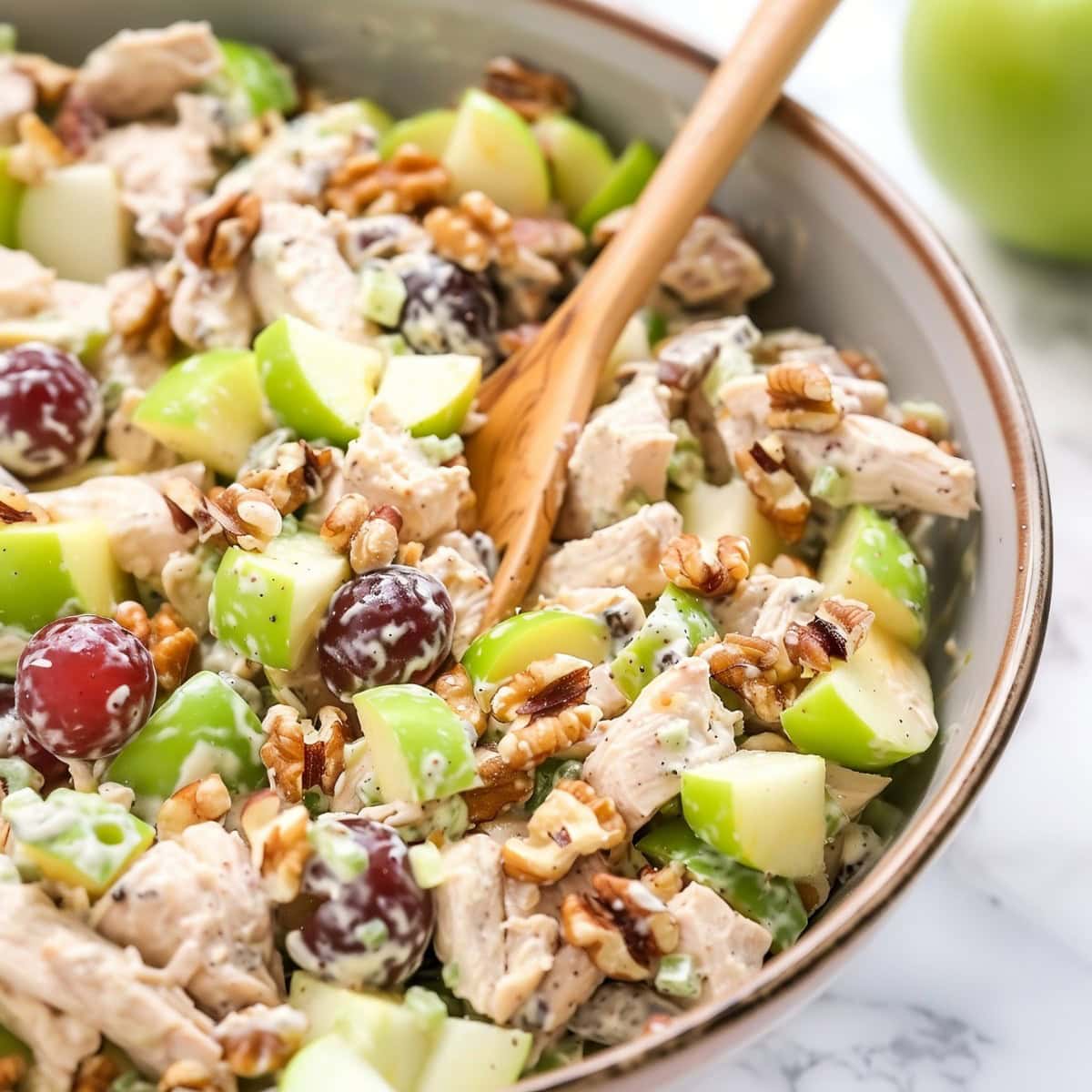 Nutty and creamy apple walnut salad in a bowl