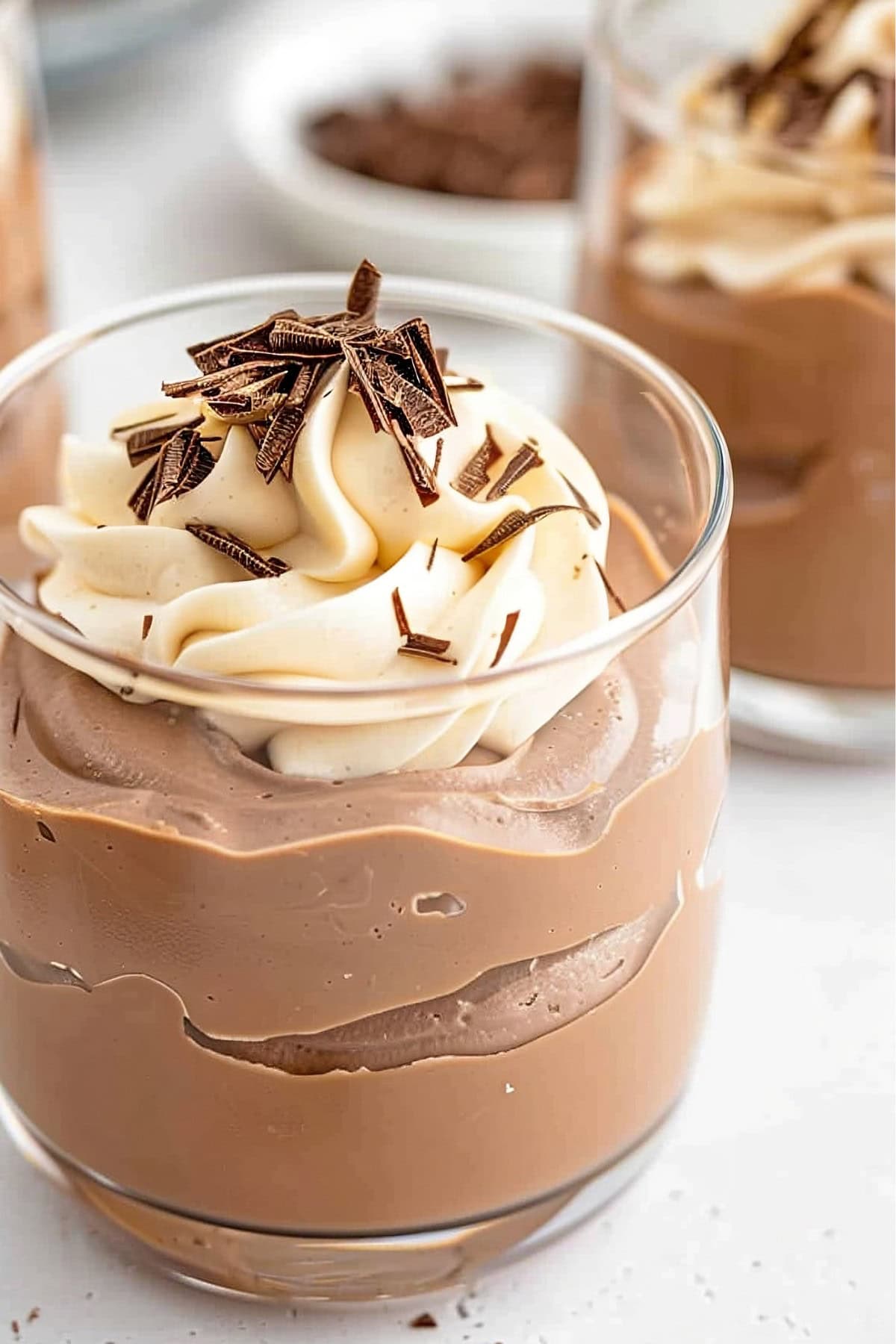 Decadent Baileys chocolate mousse garnished with chocolate shavings and whipped cream.