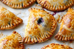 Warm blueberry hand pies with a golden-brown, crispy exterior.