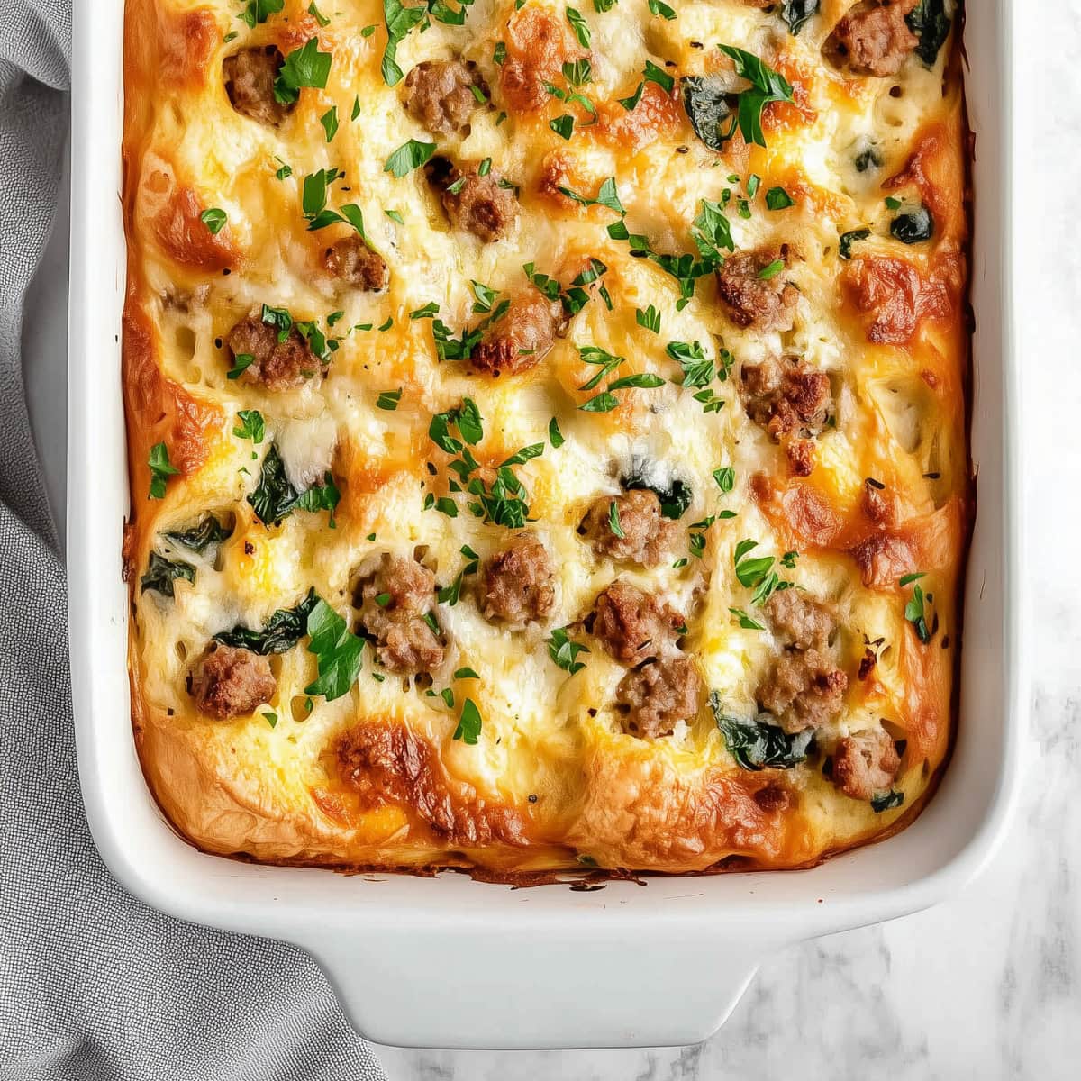 Homemade breakfast strata in a 9x13 baking dish, top view