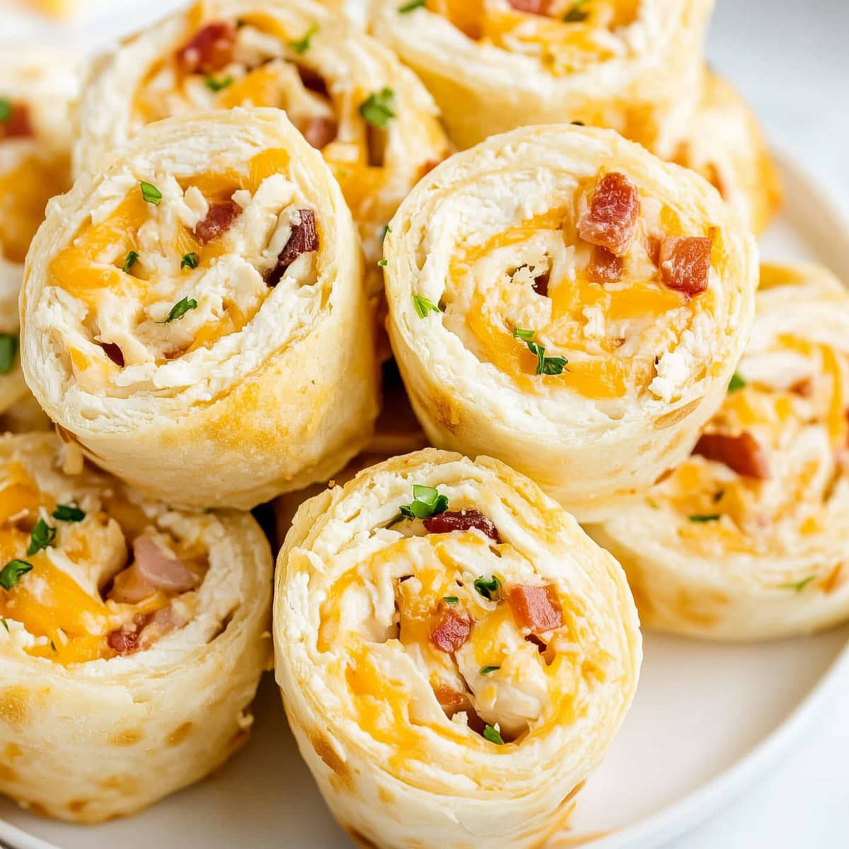 Chicken bacon ranch pinwheels with crisp edges and a creamy filling.