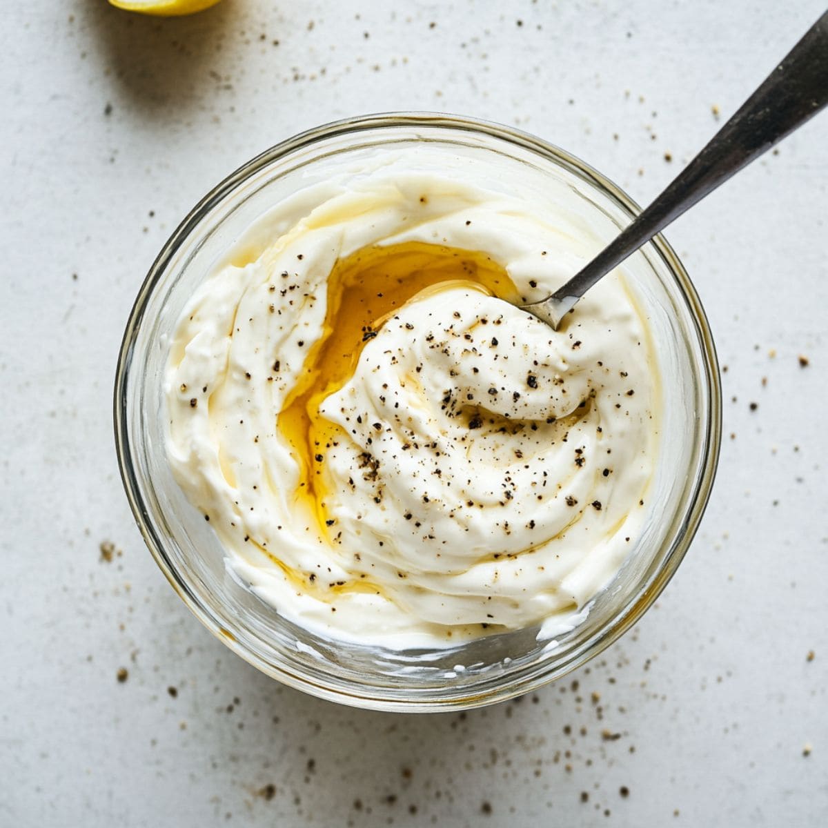 Mayonnaise dressing in a glass bowl, top view