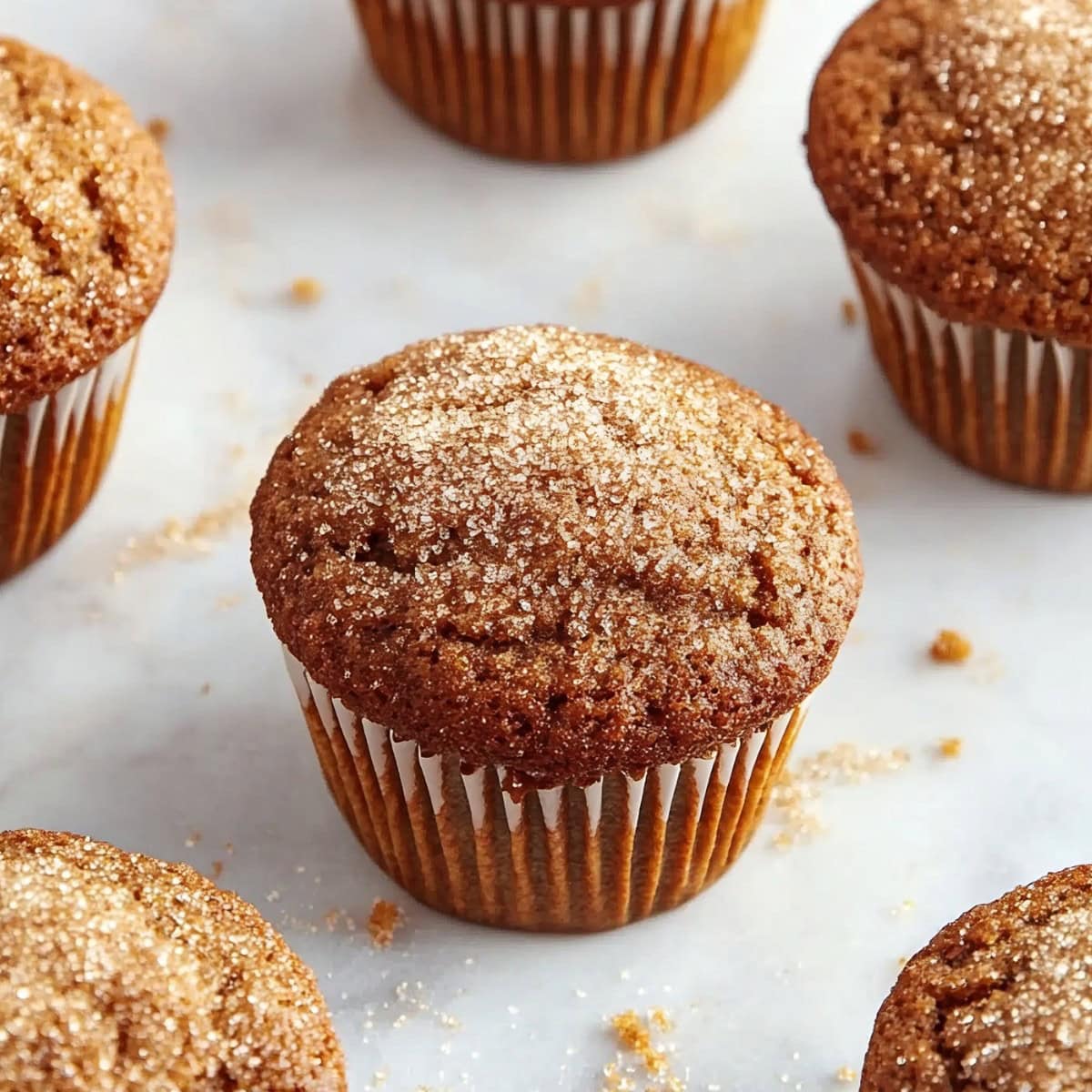 Close-up of moist gingerbread muffins with a rich, spiced aroma and coarse sugar on top