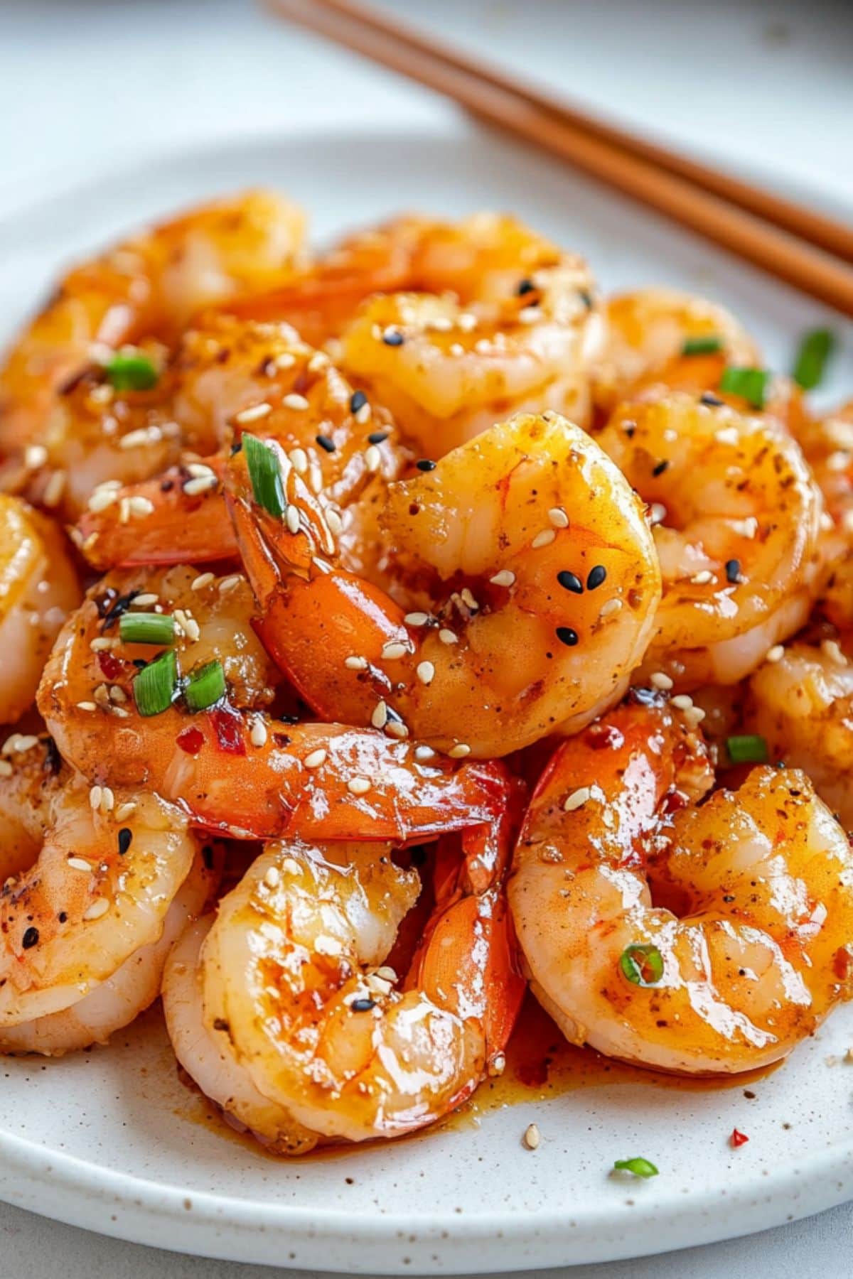 Shrimp with hibachi sauce served in a white plate.