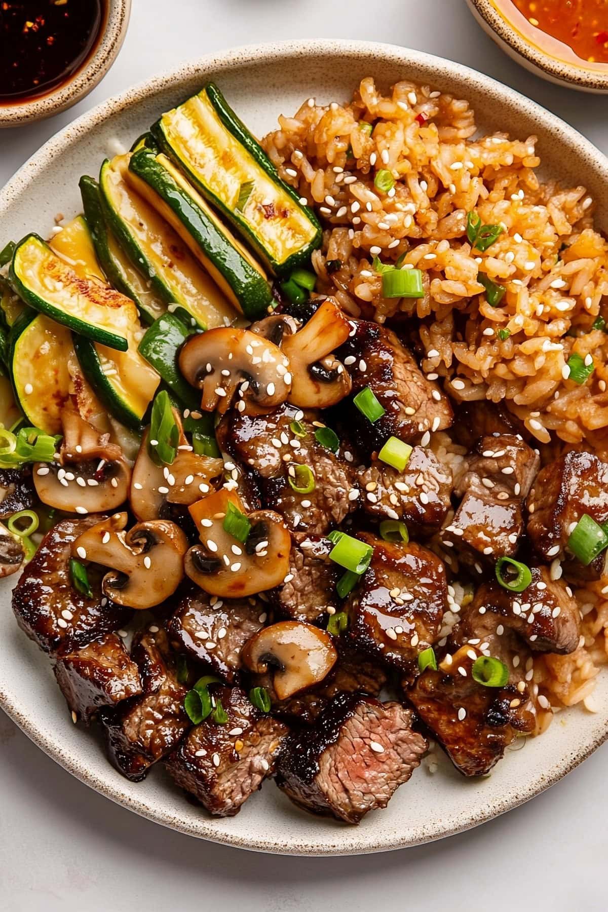 Hibachi steak with mushrooms, zucchini and sesame seeds.