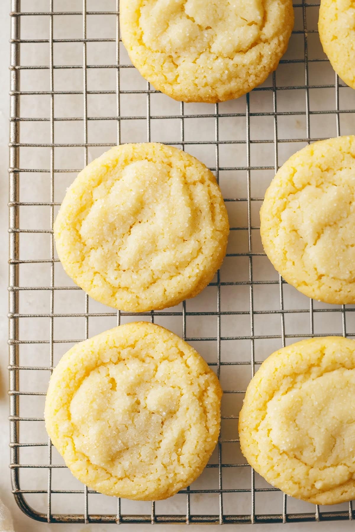 Overhead view of lemon sugar cookies on a cooling rack