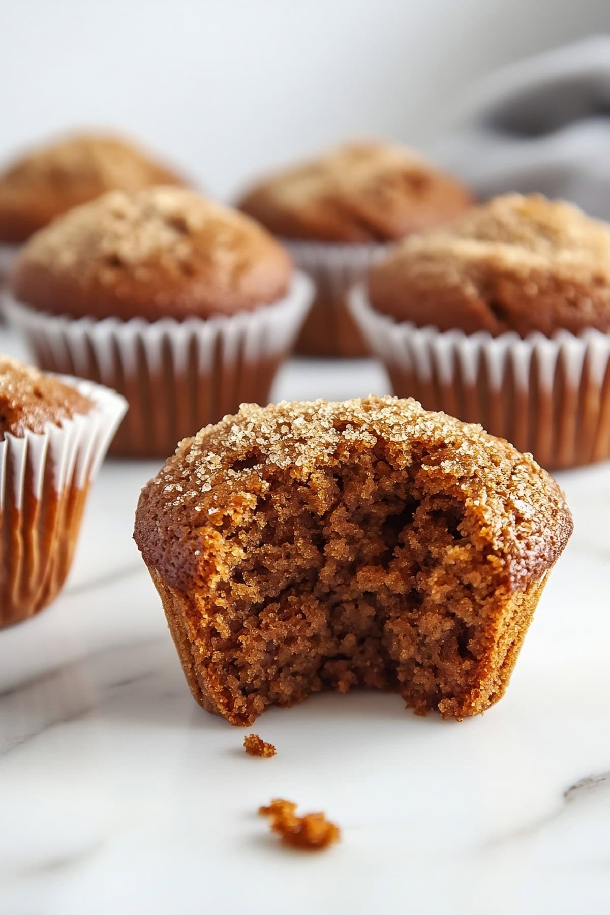 A gingerbread muffin cut in half on a marble table, close up