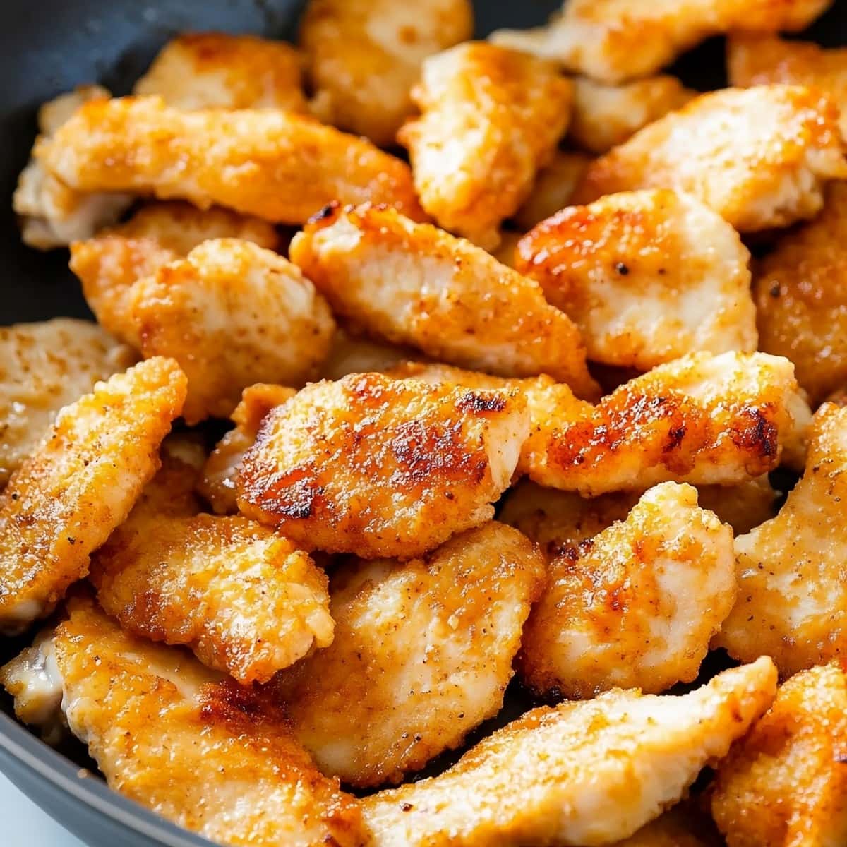 Fried Mongolian chicken in a black skillet