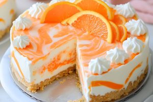 Sliced no baked orange creamsicle cheesecake.