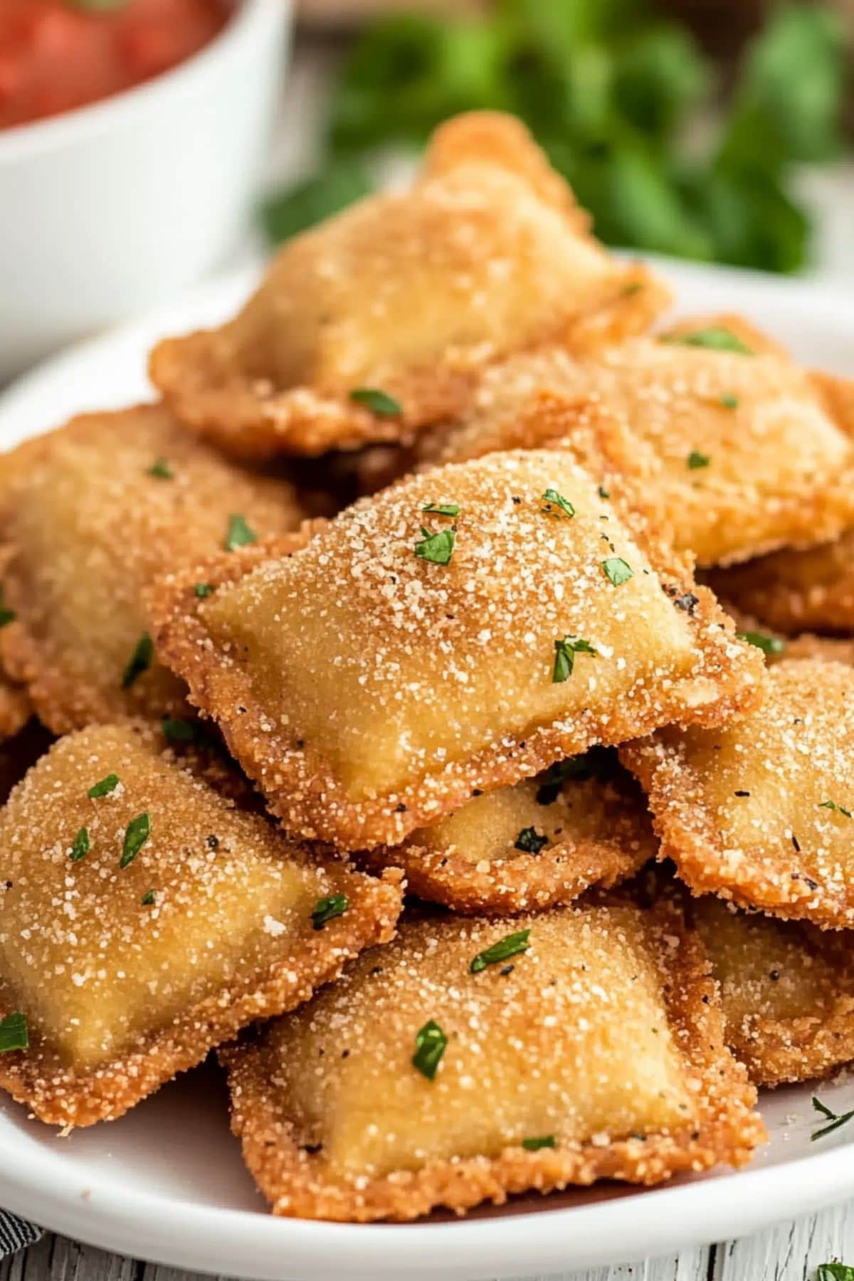 Toasted ravioli on a plate.