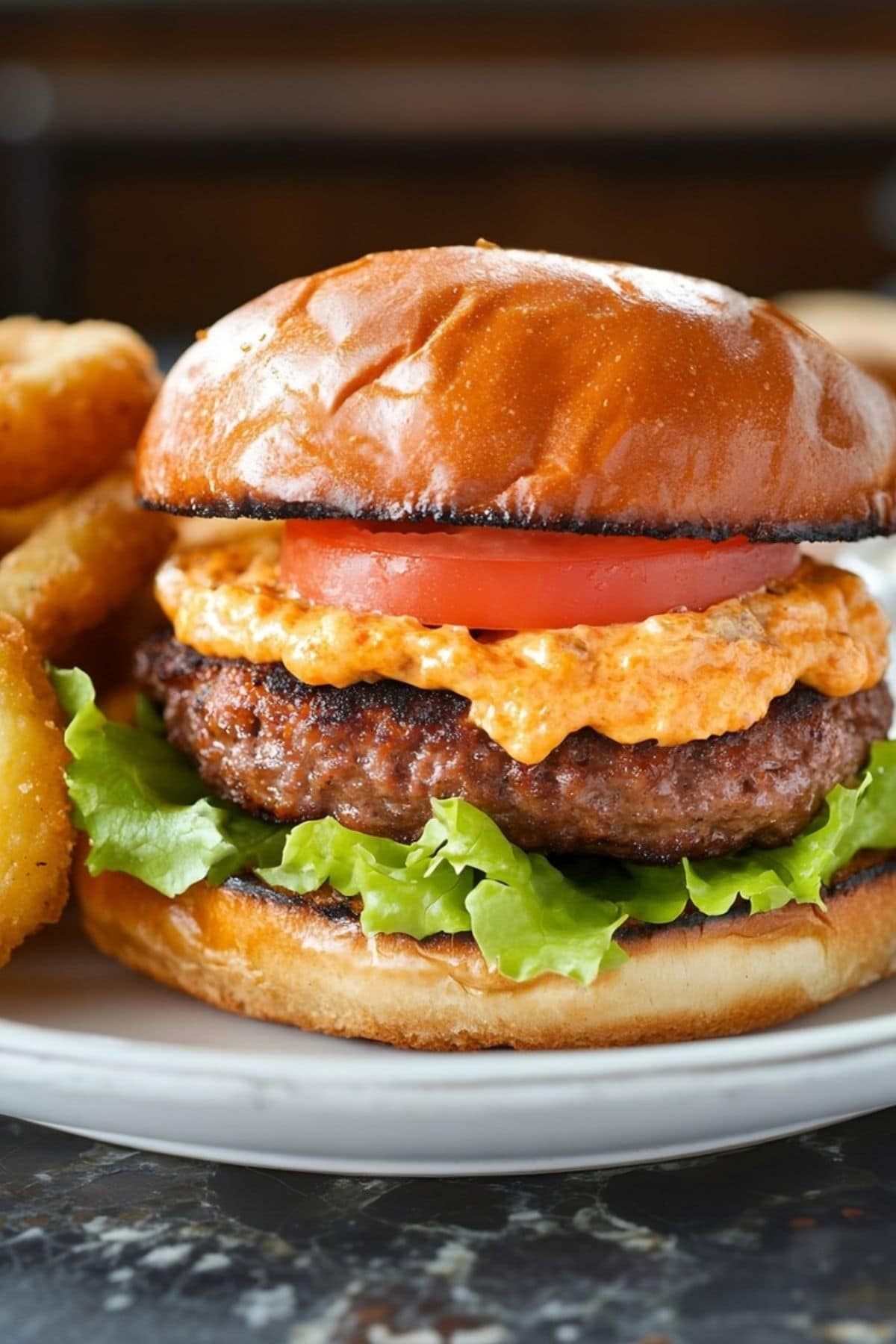 Thick juicy burger with tomatoes, lettuce, and homemade pimento cheese.