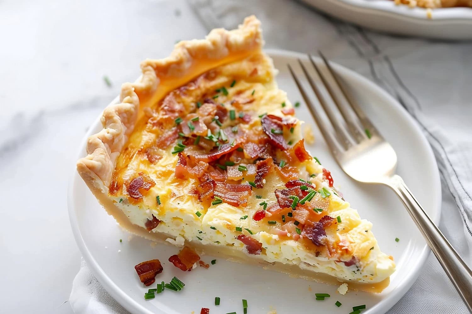 Homemade quiche Lorraine garnished with fresh herbs.