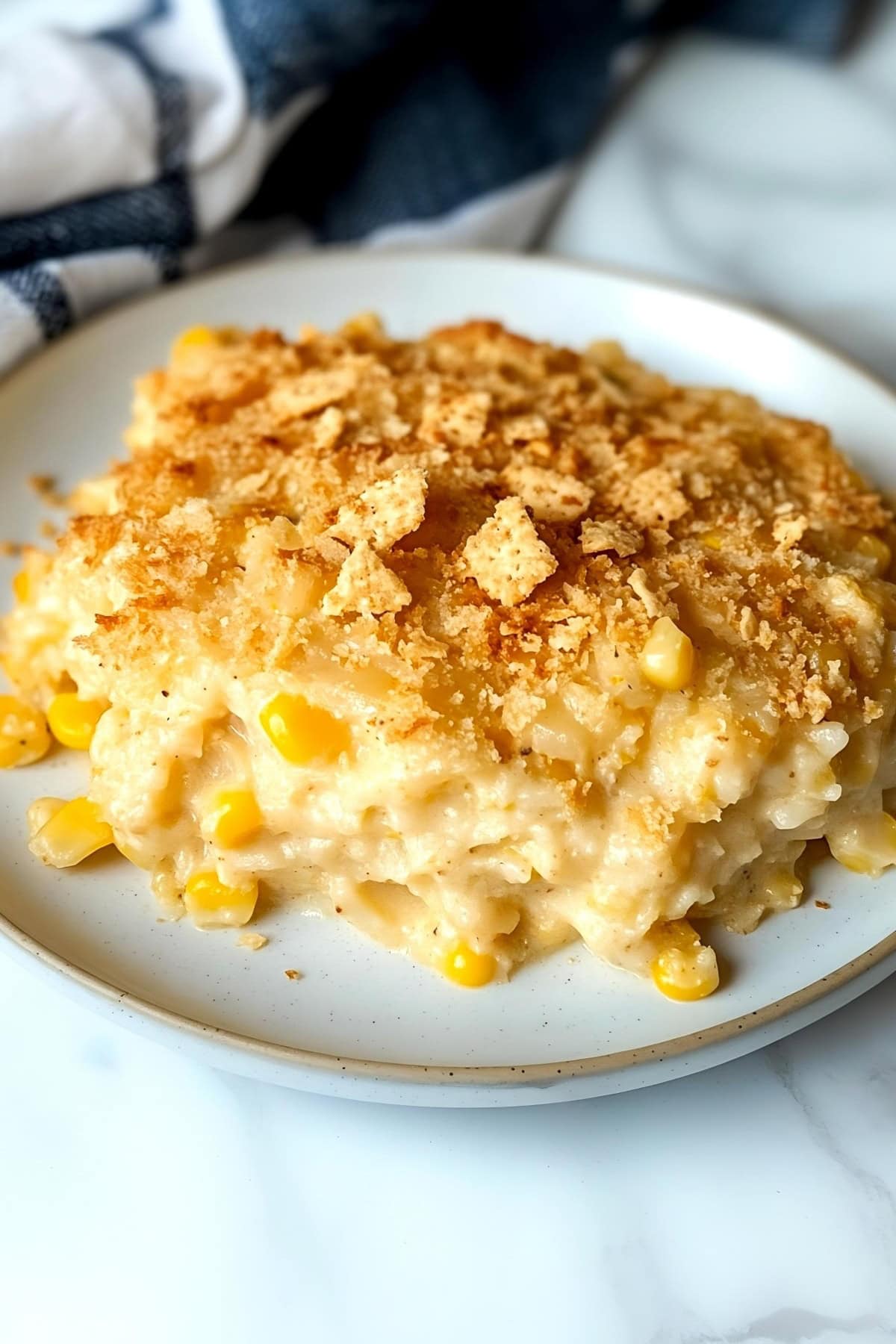 Creamy scalloped corn with crushed Ritz crackers on a plate, close up