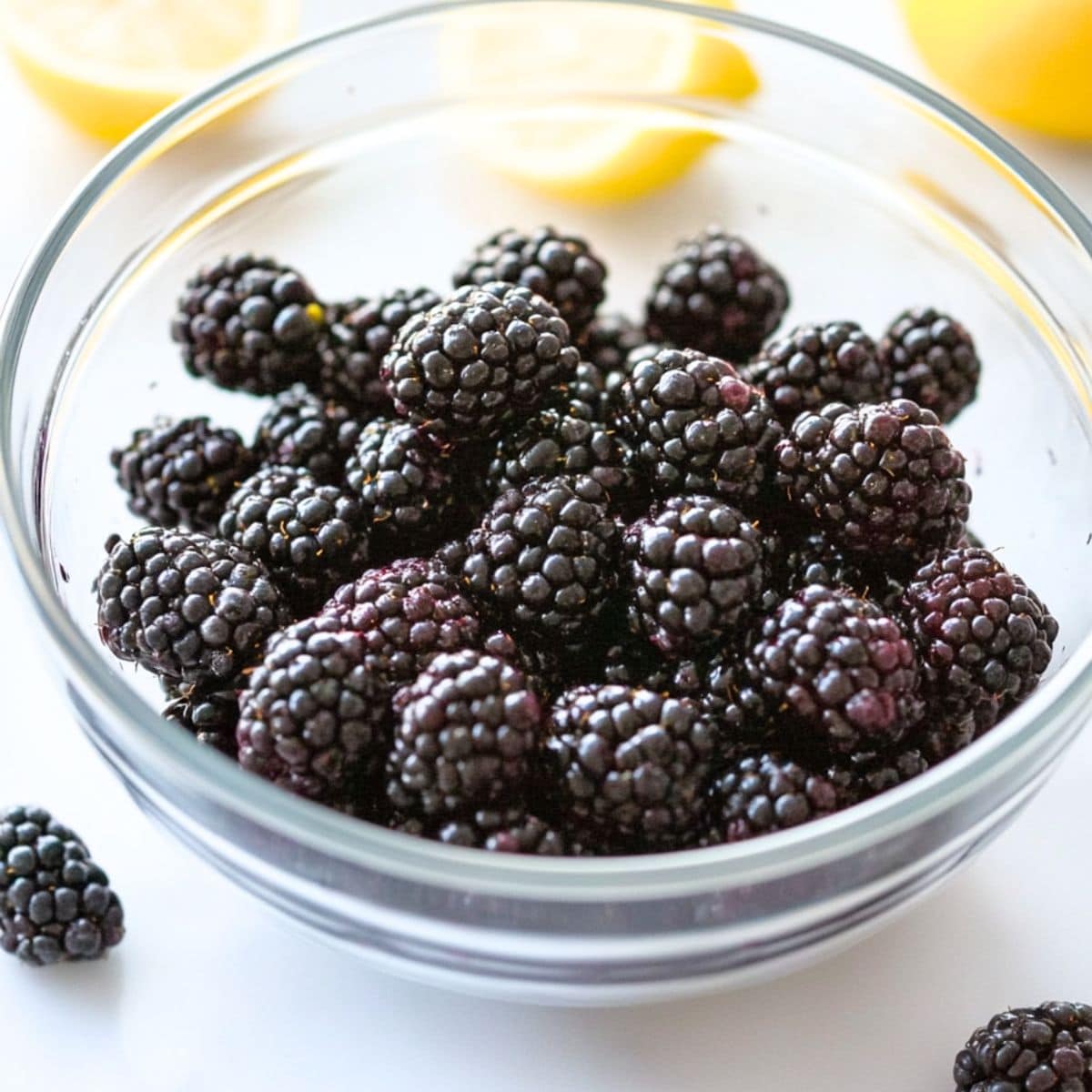 Blackberries in a large glass mixing bowl.