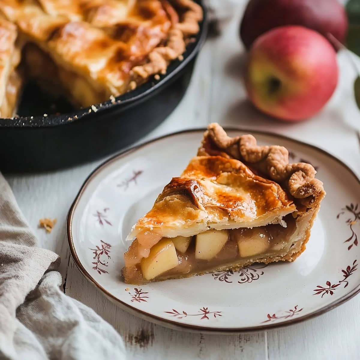 An elegant plate of sliced skillet pie on a white wooden table.