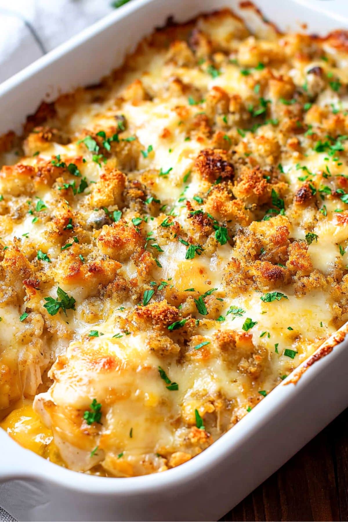 Swiss chicken casserole in a baking pan topped with stuffing mix