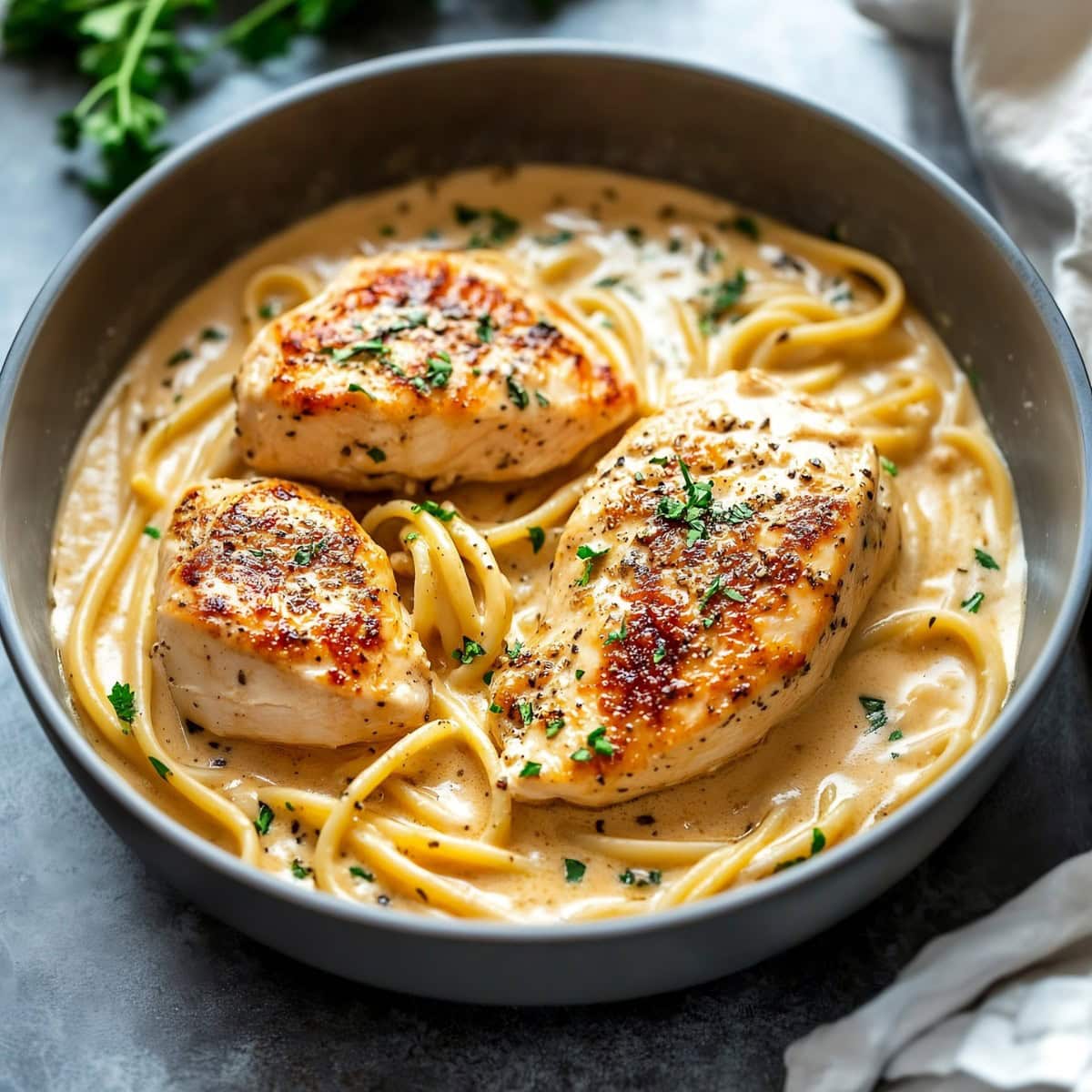 Creamy chicken diane and pasta in a bowl.