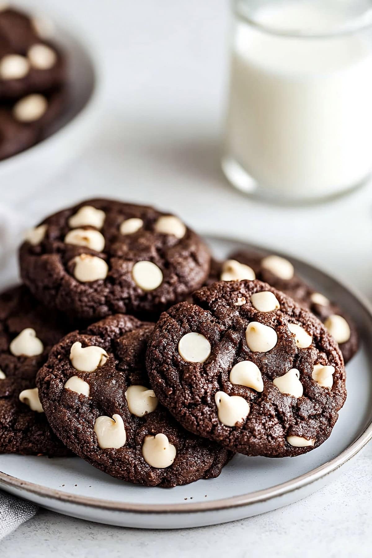 Plate of chocolate cookies with a glass of milk.