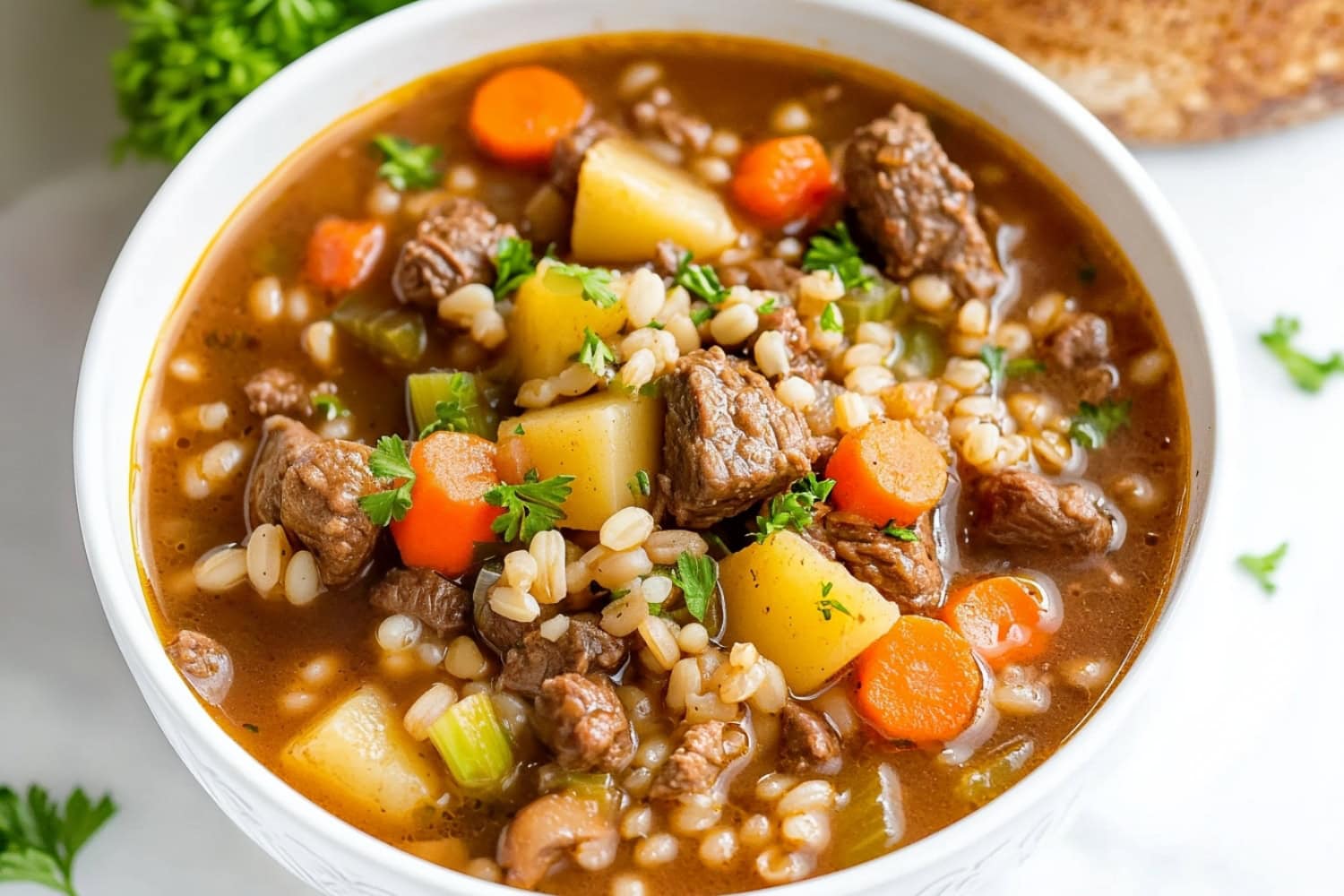 A comforting bowl of beef barley soup with tender chunks of meat and fresh veggies.