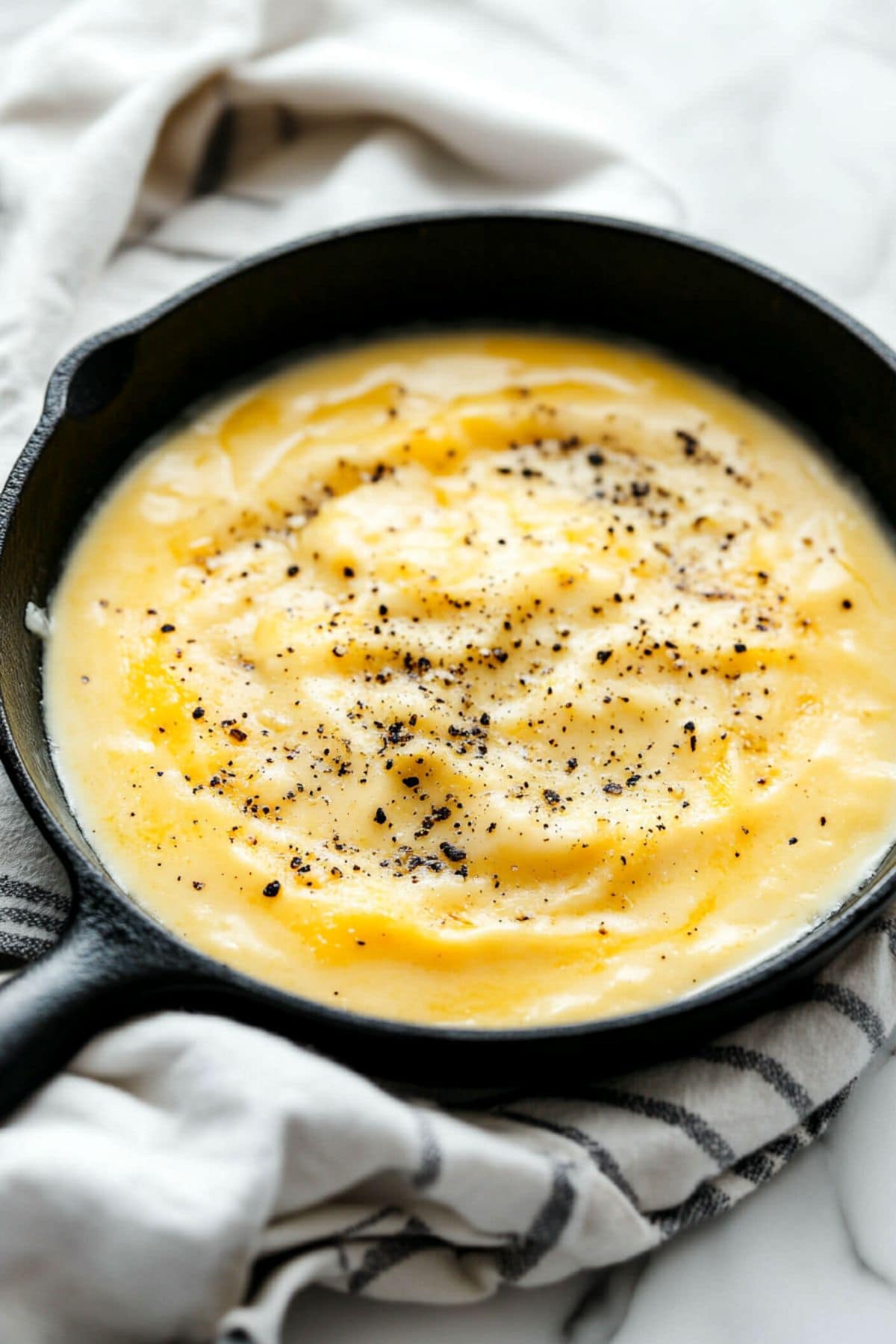 Cheesy sauce in a skillet pan.