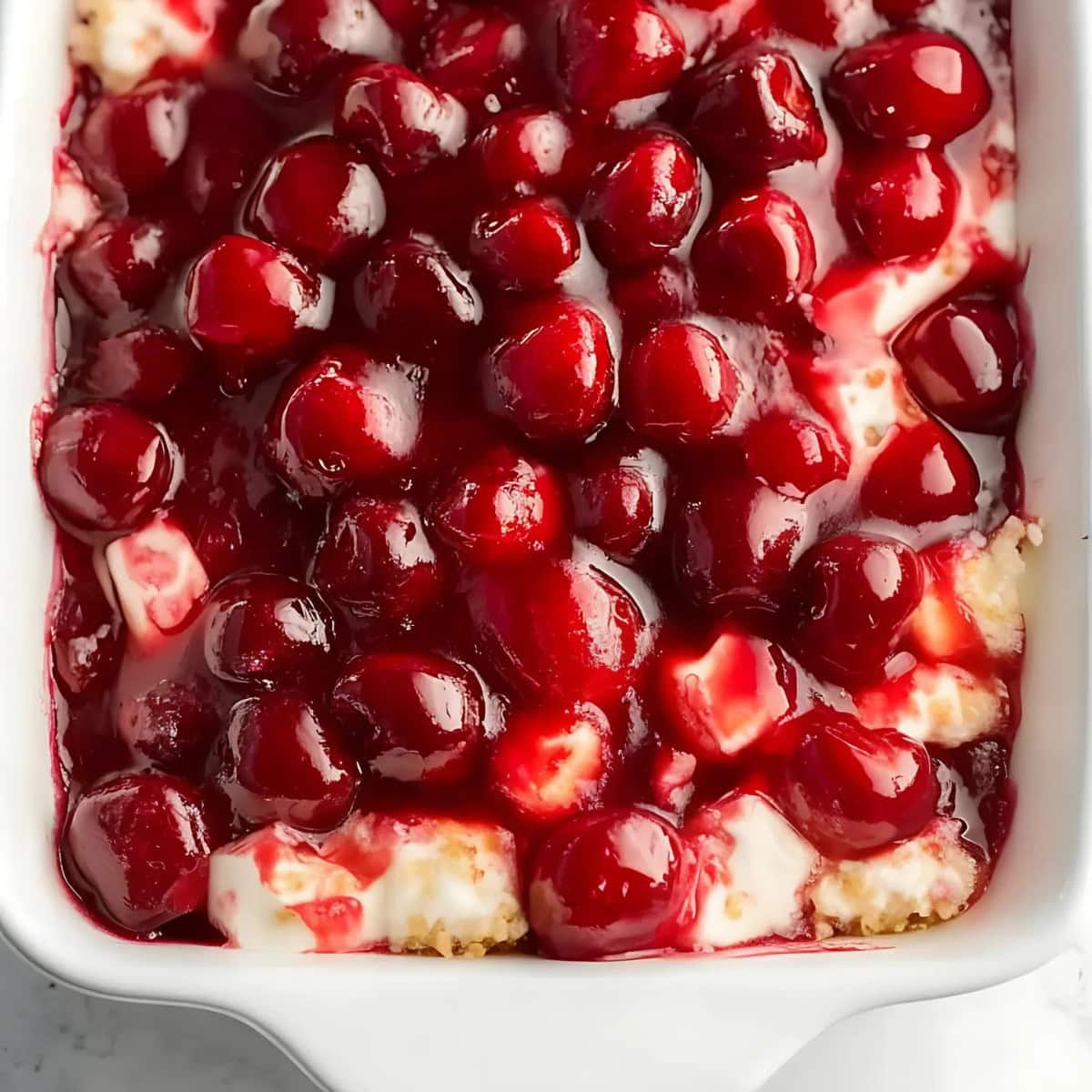 Cherries in the snow in a casserole dish.