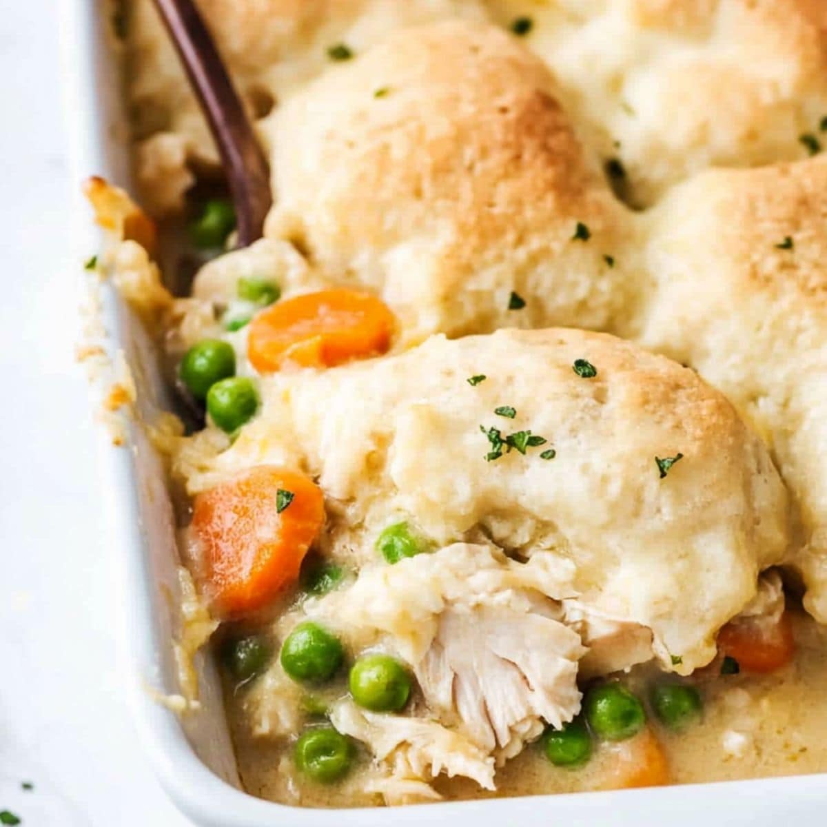 Chicken and dumplings casserole with creamy sauce baked in a casserole dish.